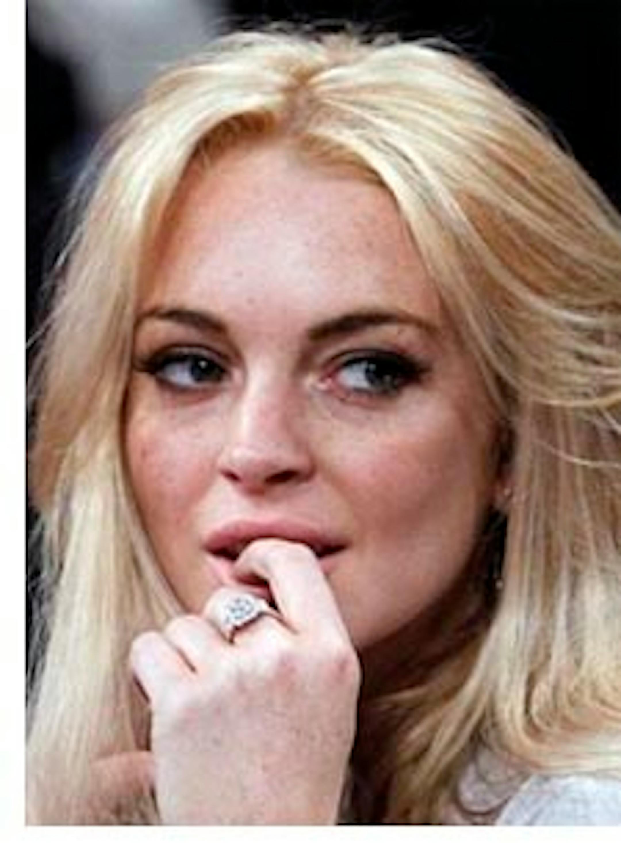 FILE - In this Jan. 9, 2011 file photo, Lindsay Lohan attends the Los Angeles Lakers New York Knicks NBA basketball game in Los Angeles. Prosecutors say they plan to charge Lohan on Wednesday Feb. 9, 2011 with felony grand theft of a $2,500 necklace reported stolen from a jewelry store.(AP Photo/Alex Gallardo, File)