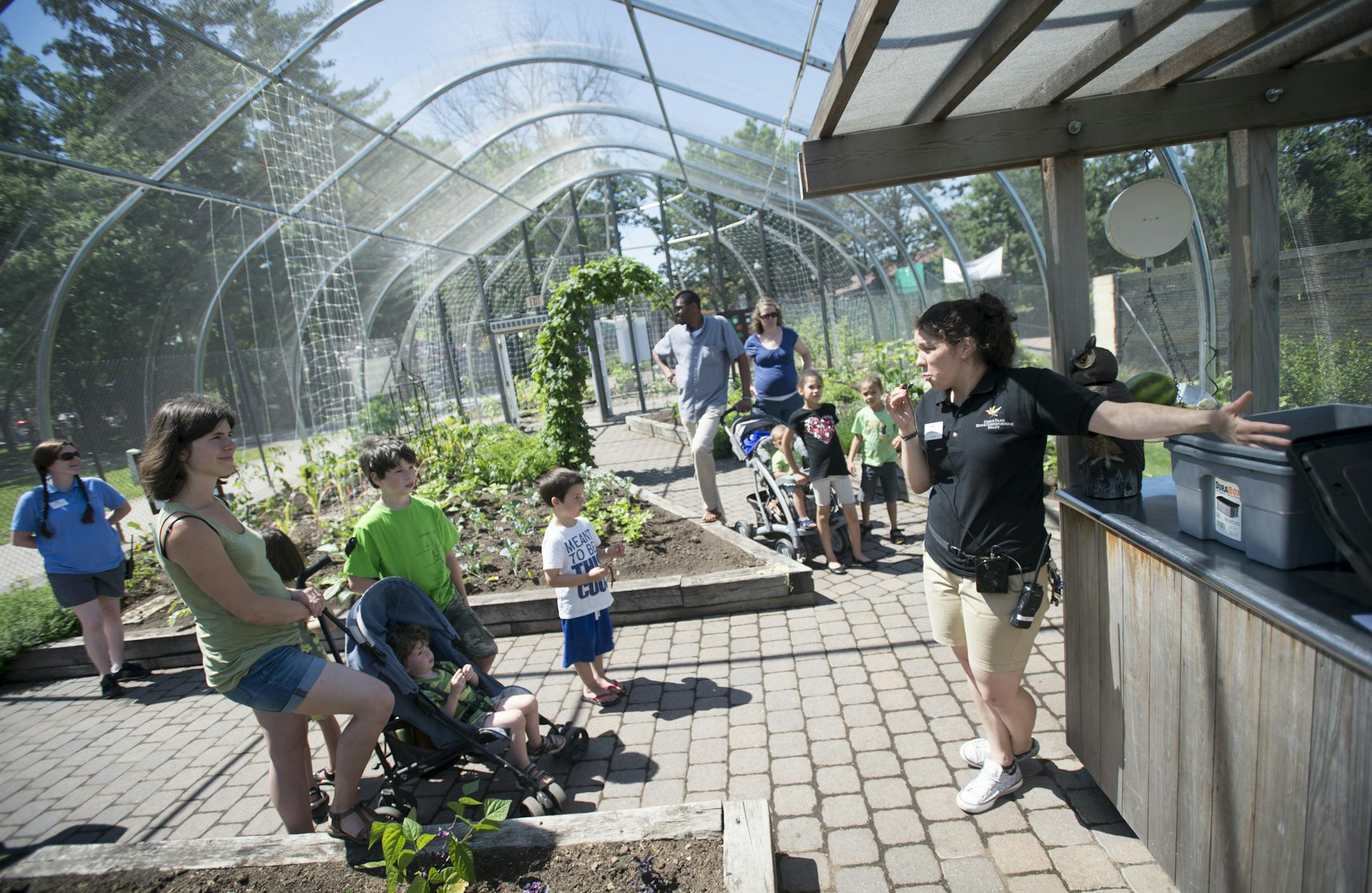 Education specialist Camille Karpik, right, gave a composting demonstration to families visiting Komo Zoo's Edible Garden Friday. ] Aaron Lavinsky &#x2022; aaron.lavinsky@startribune.com The edible garden at the Como Zoo opened on Friday, June 12, 2015 in St. Paul.