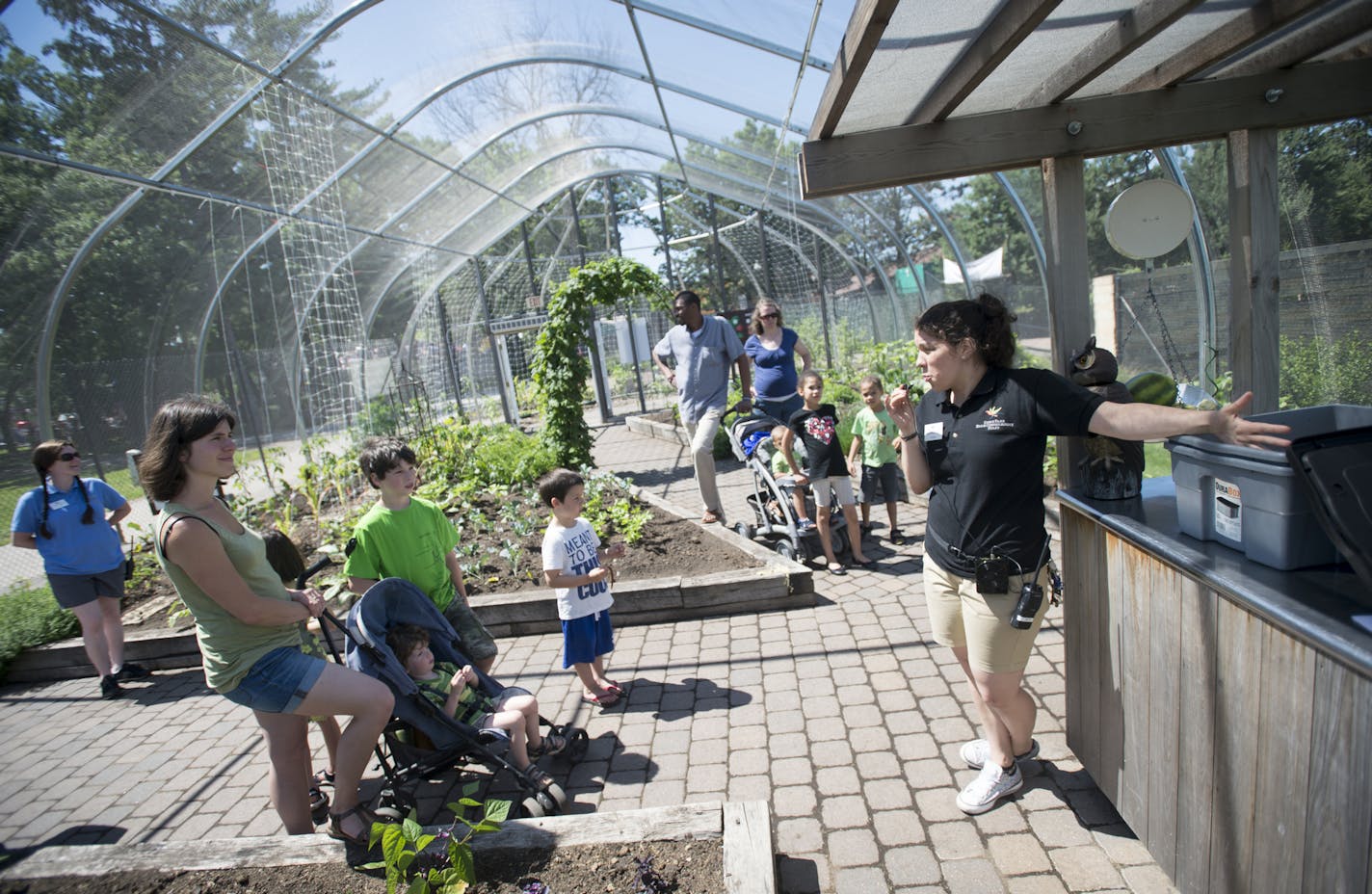 Education specialist Camille Karpik, right, gave a composting demonstration to families visiting Komo Zoo's Edible Garden Friday. ] Aaron Lavinsky &#x2022; aaron.lavinsky@startribune.com The edible garden at the Como Zoo opened on Friday, June 12, 2015 in St. Paul.