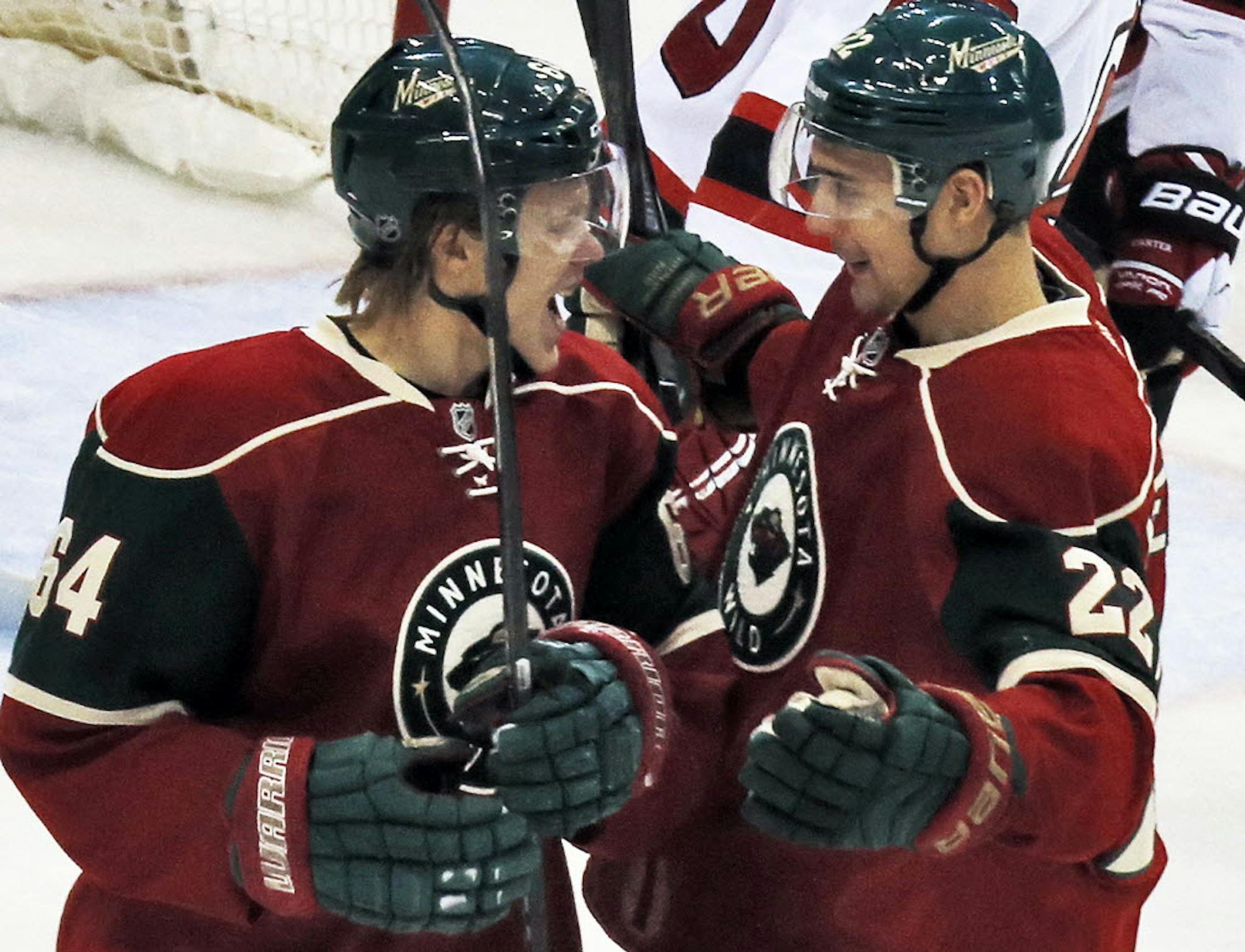 Mikael Granlund (64) celebrated with teammate Nino Niederreiter after Granlund scored his first goal of the season Sunday night against New Jersey.