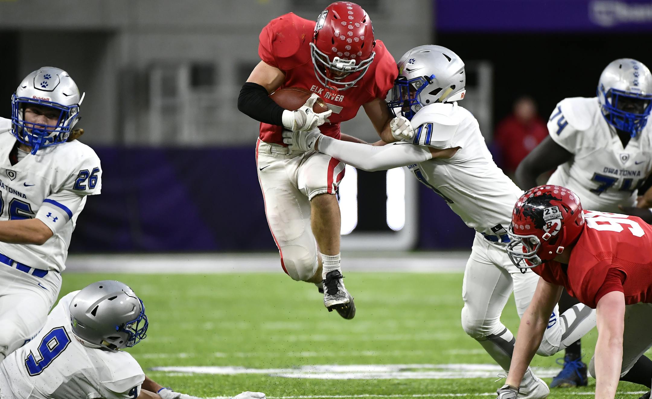 Elk River running back Sam Gibas ( 15) rushed the ball past Owatonna defender Brett Solie (11) during the first quarter. ] (AARON LAVINSKY/STAR TRIBUNE) aaron.lavinsky@startribune.com Elk River played Owatonna in a Class 5A semifinal game of the state tournament on Friday, Nov. 18, 2016 at US Bank Stadium in Minneapolis, Minn.
