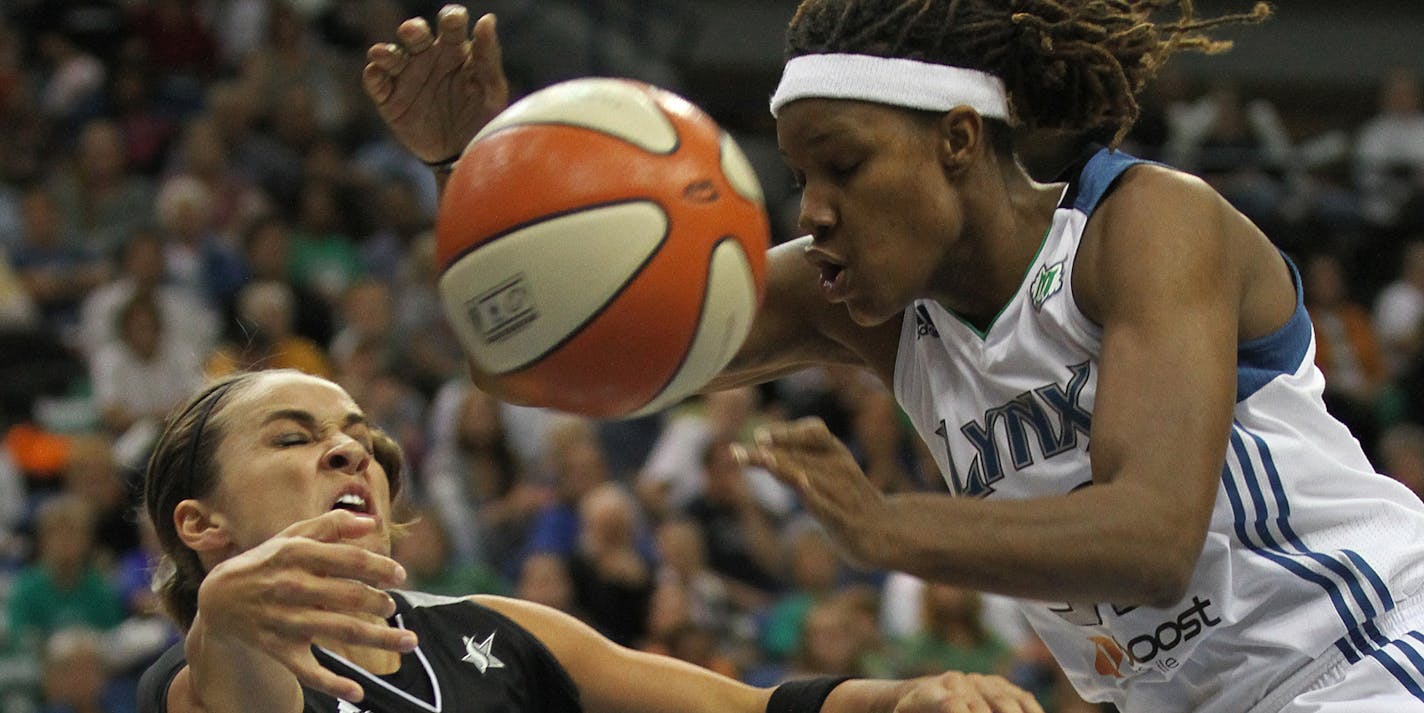 Becky Hammon (25) passes the ball past Rebekkah Brunson during the first quarter of the final Minnesota Lynx playoff game against the San Antonio Silver Stars. The Lynx eliminated the Silver Stars 85-67. ] SHARI L. GROSS * sgross@startribune.com , September 20, 2011, Minneapolis, Minn, Target Center ORG XMIT: MIN2015092119415616