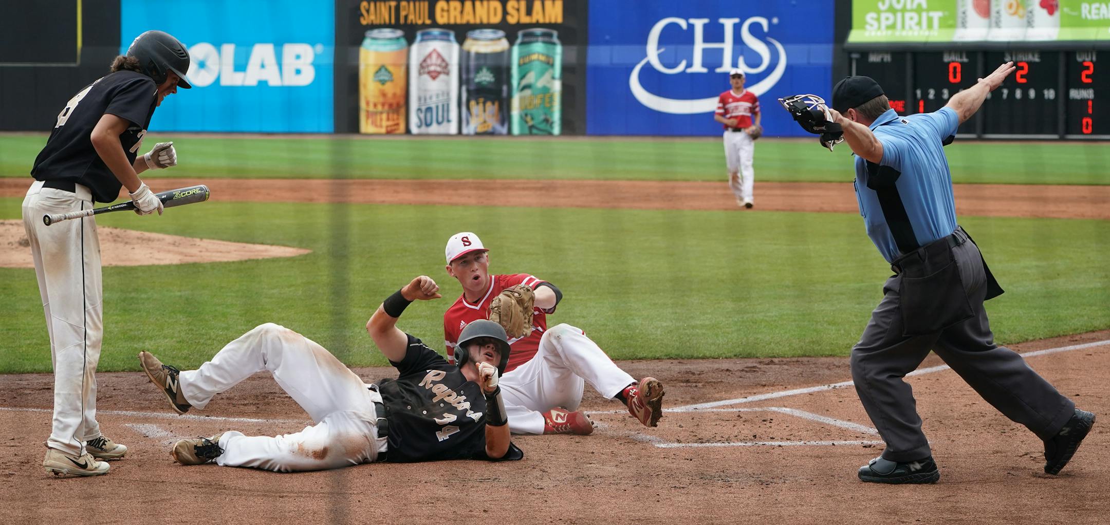 East Ridge runner Cam Hunter (34) was safe at home plate which was covered by Stillwater pitcher Will Frisch (15) in the first inning. ] Shari L. Gross ¥ shari.gross@startribune.com East Ridge upset top seeded Stillwater 6-5 in eight innings in a state 4a semifinal baseball game at CHS Field in St. Paul, Minnesota on Saturday, June 15, 2019.