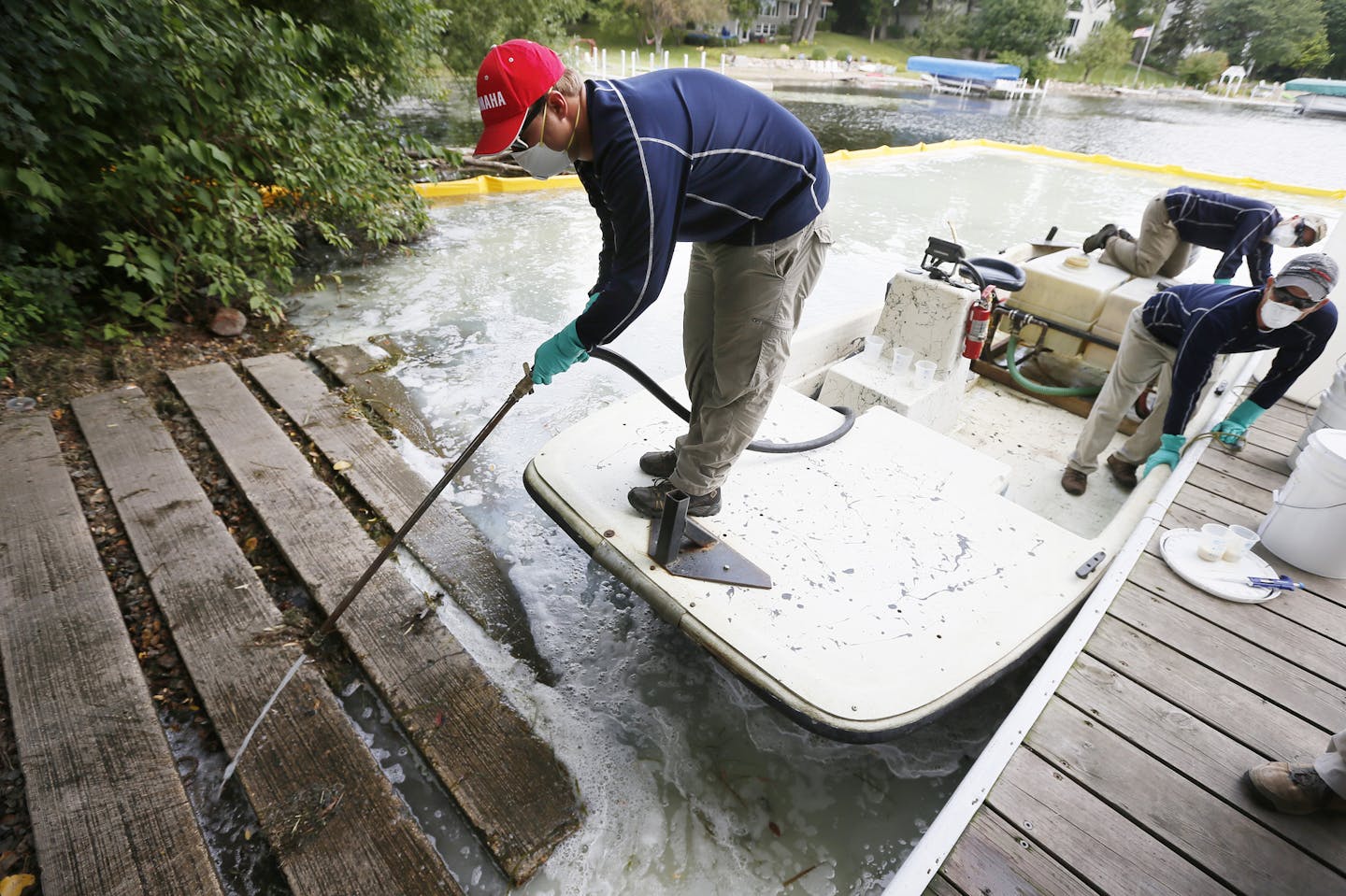 David Hillstrom treated an area on Christmas Lake for zebra mussels .Federal and state crews tested a product called Zequanox to try an control and infestation of zebra mussels on Christmas Lake Monday September 8 , 2014 in Shorewood, MN . A 50x60 feet section of the lake at the public access was treated . ] Jerry Holt Jerry.holt@startribune.com