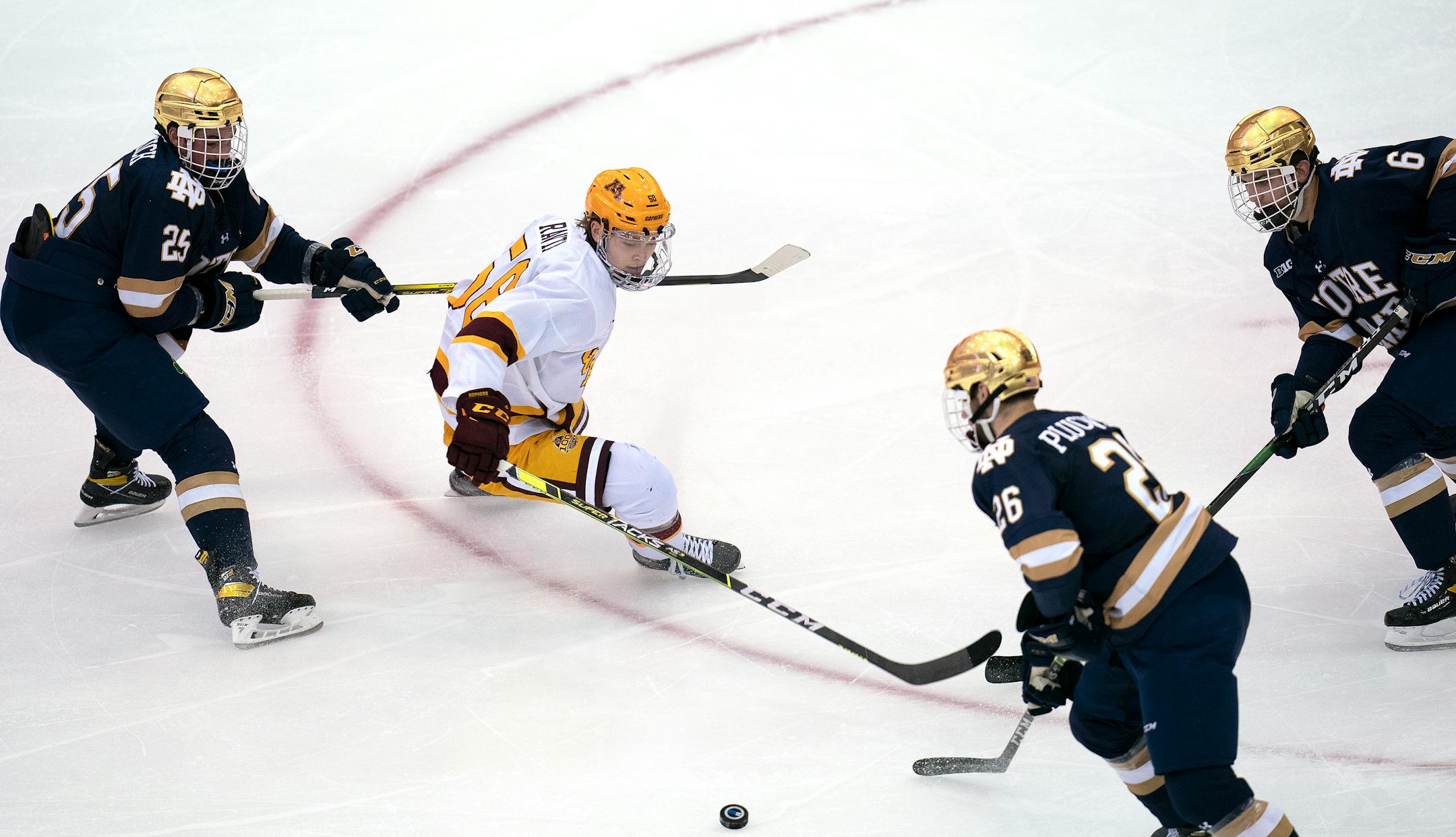 Gophers forward Sampo Ranta battled Notre Dame's Solag Bakich (25), Zach Plucinski (26) and Jake Boltman during the second period.