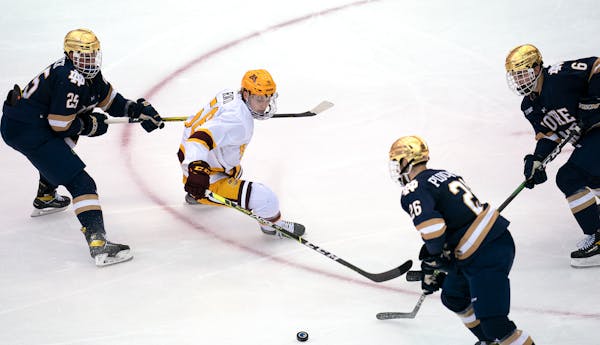 Gophers forward Sampo Ranta battled Notre Dame's Solag Bakich (25), Zach Plucinski (26) and Jake Boltman during the second period.