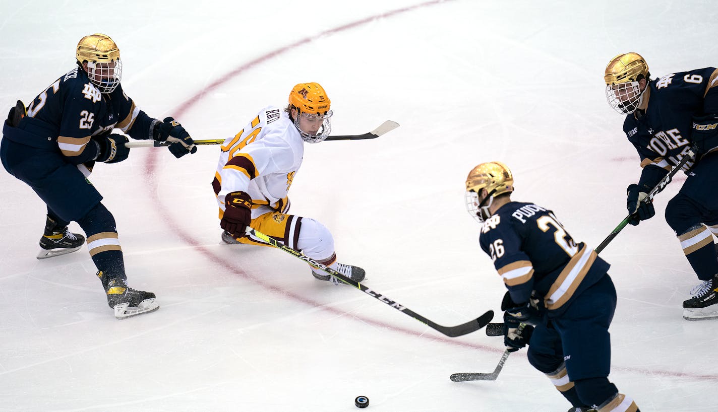 Gophers forward Sampo Ranta battled Notre Dame's Solag Bakich (25), Zach Plucinski (26) and Jake Boltman during the second period.