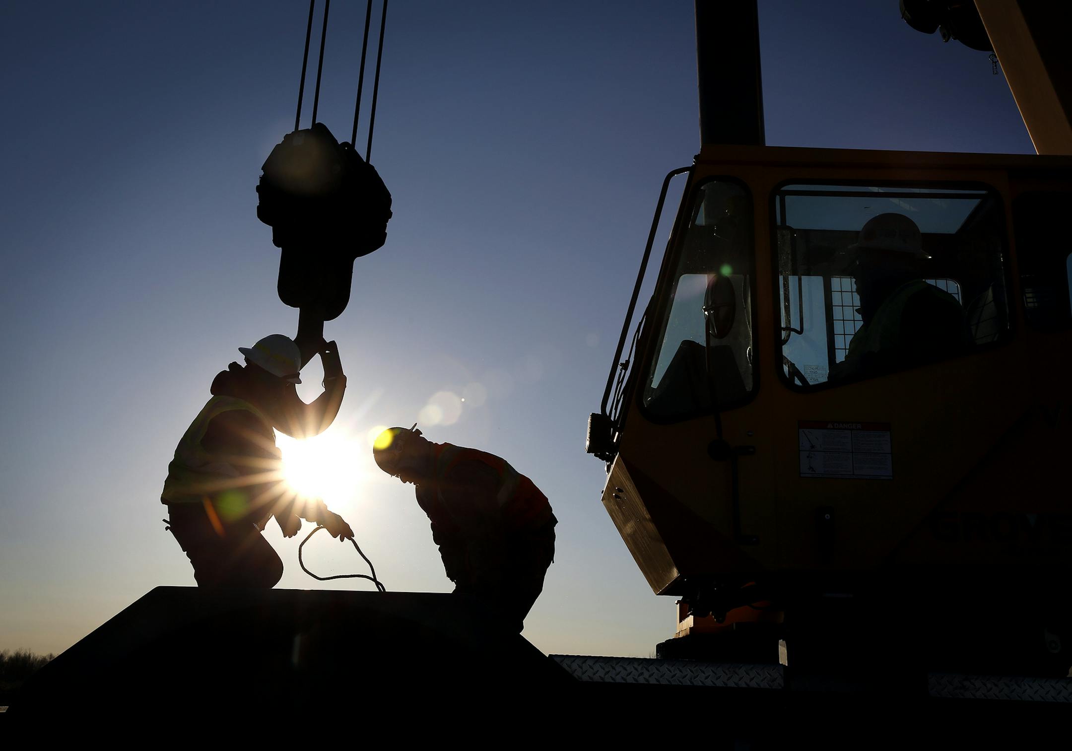 Iron workers set up a crane to move steel for the construction of buildings on the site of Essar Steel Minnesota's taconite mine project in Nashwauk, Minn.