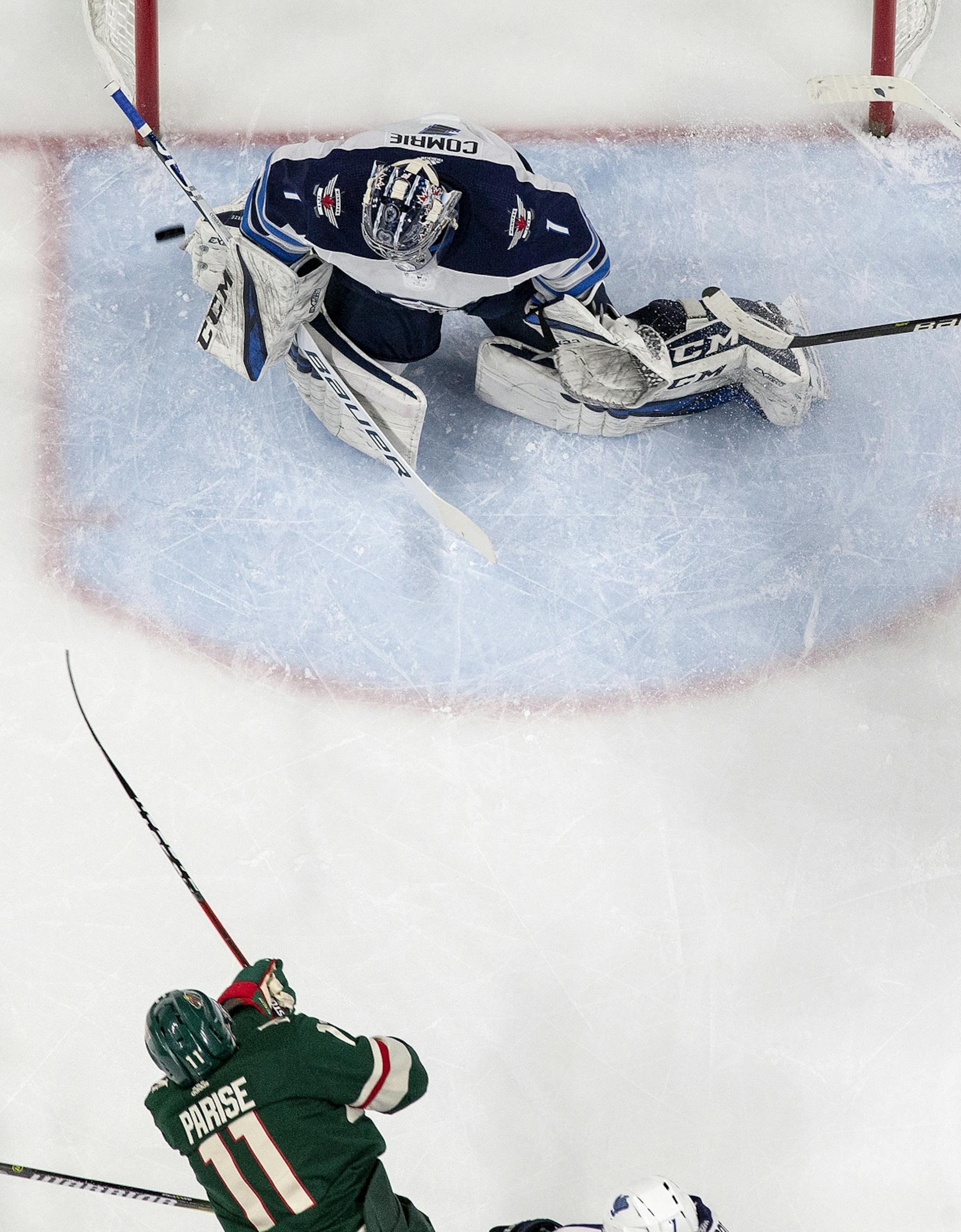 Zach Parise (11) shot the puck past Jets goalie Eric Comrie (1) for his second goal in the first period.