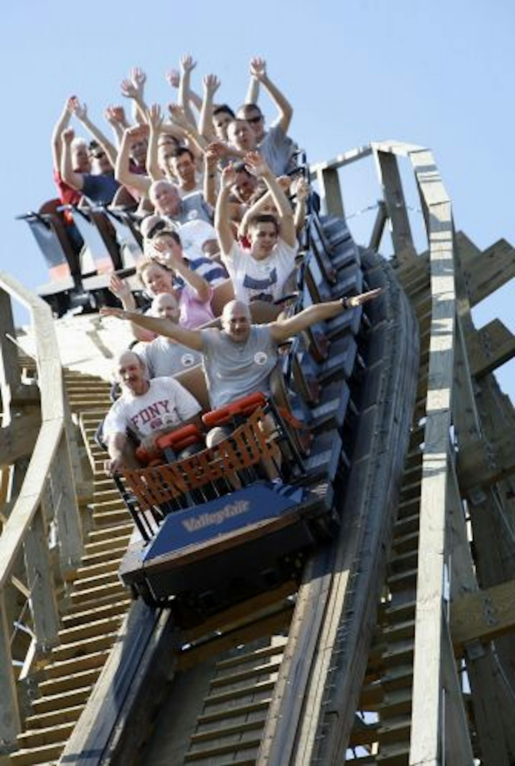 RENEE JONES SCHNEIDER � reneejones@startribune.com Shakopee, MN - July 27, 2007 - Rollar coaster enthusiasts made sure to raise their hands as go down the first big decent of Valleyfair's Renagade roller coaster Friday morning at the Coaster Craze event where the roller coaster fans got exclusive rides before the park opened. More than 50 people from around the states came to Valleyfair Friday morning for the event, including Andrew Weiss of Las Vegas who is a member of the American Coaster Enth