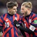 Christian Pulisic (10) and Walker Zimmerman (3) of the U.S.A. celebrate a goal by Pulisic in the second half Wednesday, Feb. 2, at Allianz Field in Sa