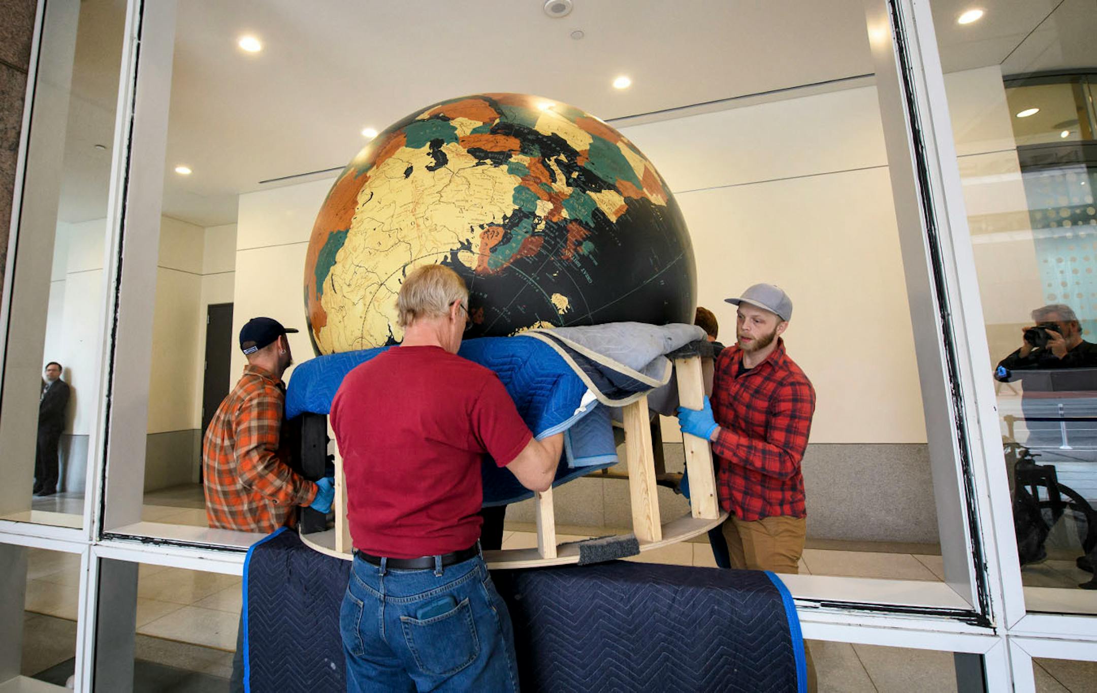 Workers from Blue Rhino Studio in Eagan handled the restoration and placement of the Star Tribune globe. A window had to be removed to place the globe.