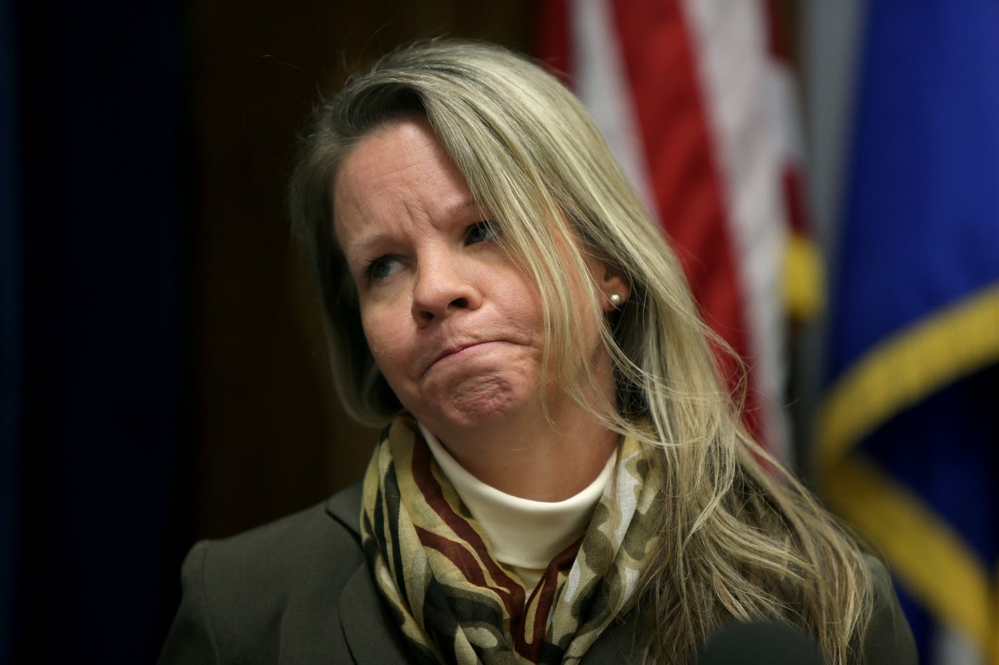 Debt collector victims, including Jennifer Dahlke, stood near Minnesota Attorney General Lori Swanson as she talked about suing a Minnesota debt buyer.