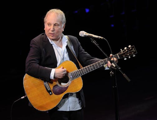 FILE - This April 2, 2012 file photo shows singer Paul Simon performing at "A Celebration of Paul Newman's Dream" to benefit "SeriousFun" an association of Hole in the Wall Camps at Avery Fisher Hall in New York. Police in Connecticut say Paul Simon and his wife, singer Edie Brickell, have been arrested on disorderly conduct charges. A New Canaan police spokeswoman provided no other details, except to say the arrests stemmed from an incident Saturday. An arraignment in Norwalk Superior Court is