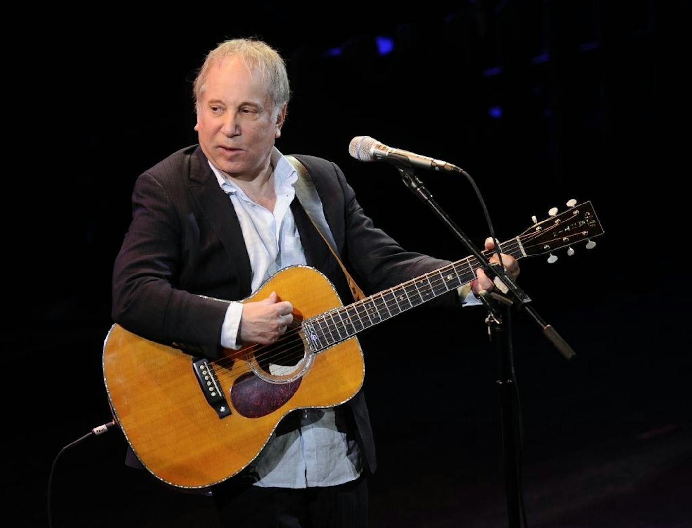 FILE - This April 2, 2012 file photo shows singer Paul Simon performing at "A Celebration of Paul Newman's Dream" to benefit "SeriousFun" an association of Hole in the Wall Camps at Avery Fisher Hall in New York. Police in Connecticut say Paul Simon and his wife, singer Edie Brickell, have been arrested on disorderly conduct charges. A New Canaan police spokeswoman provided no other details, except to say the arrests stemmed from an incident Saturday. An arraignment in Norwalk Superior Court is