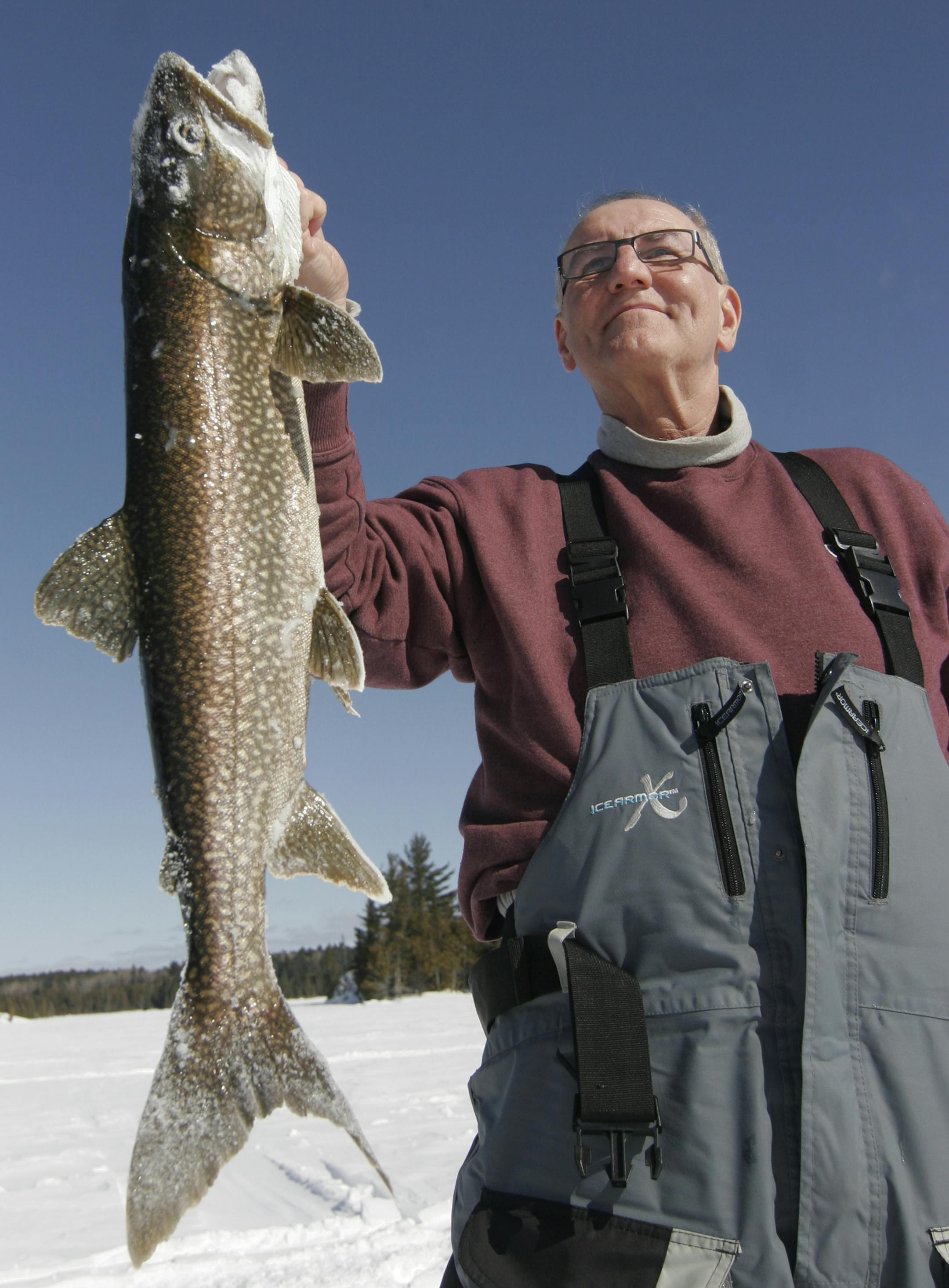 Tom Szukis of Duluth holds a nearly 30-inch lake trout he caught during an Ontario ice fishing trip."He pulled off 30 feet of line right away,'' Szukis said. "That's what you come for.'' Star Tribune photo by Doug Smith