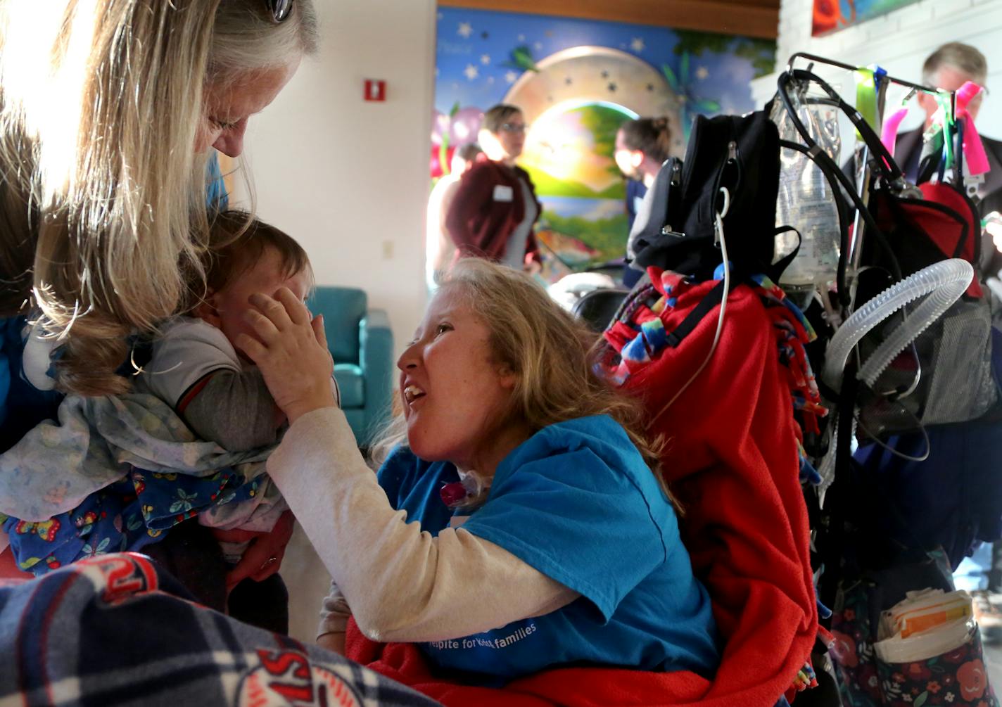 Crescent Cove, an area nonprofit, has been busy renovating a property purchased last spring and will be the region's first independent children's hospice and only the third in the nation. Families are celebrating the opening of a hospice center where end-of-life care will be provided to ill children. Here, Tana Wall, 21, right, and her mom Jill Wall, left, dote on Harmon, four months, the son of Crescent Cove founder Katie Lindenfelser and seen Saturday, Nov. 11, 2017, in Brooklyn Center, MN. Ta