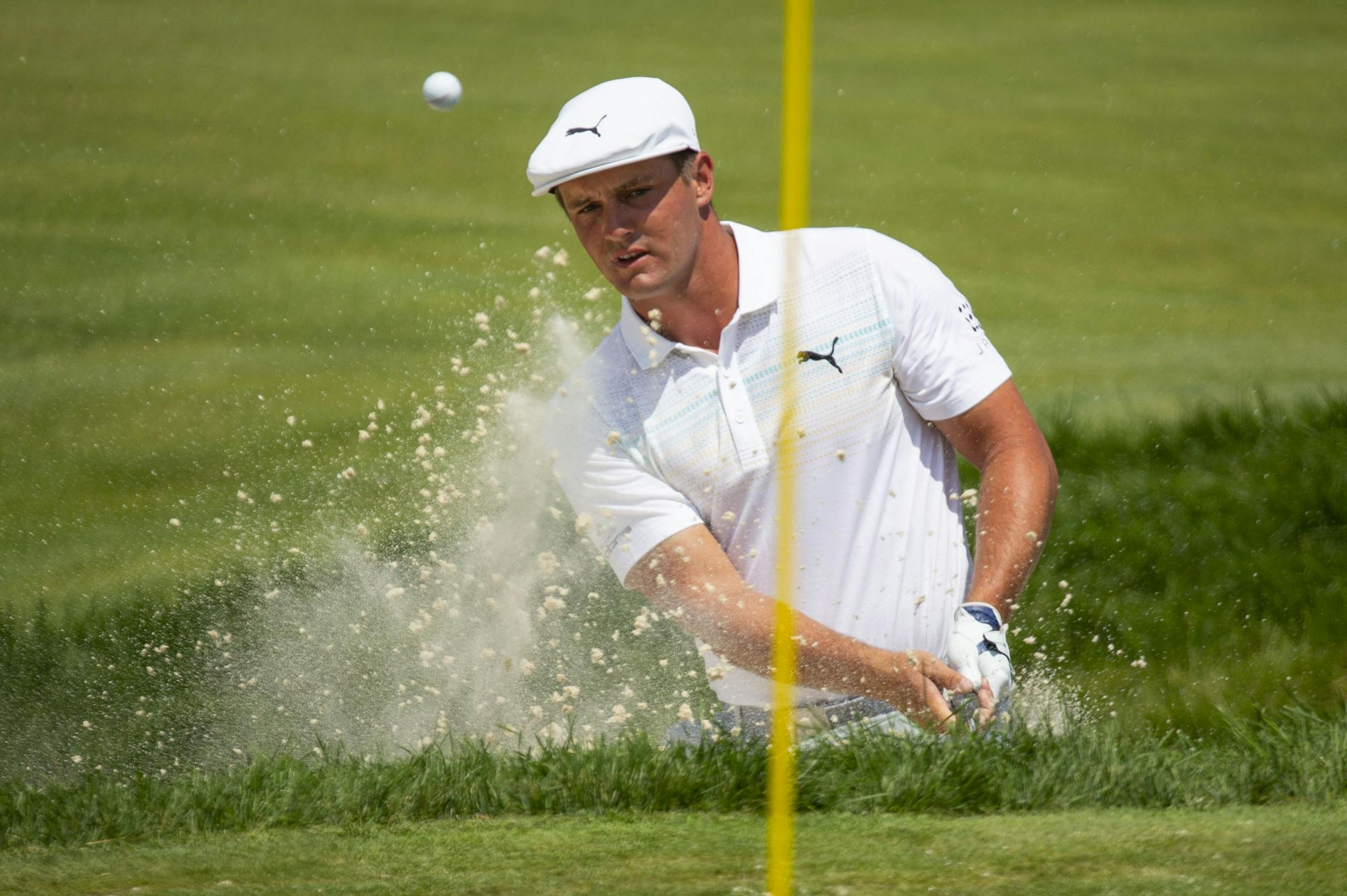 Bryson DeChambeau hits a ball out of a bunker on the third hole. ALEX KORMANN ¥ alex.kormann@startribune.com Competitors for the 3M Open took to the course on Saturday.