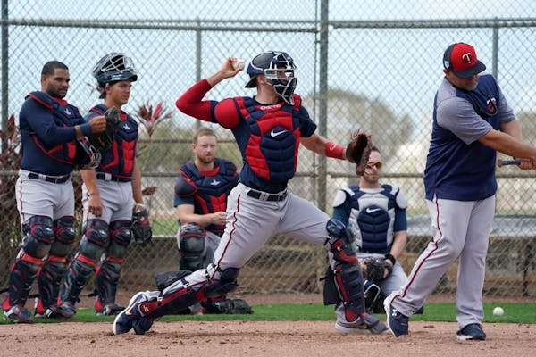 Jason Castro made a throw during a workout for catchers at spring training.
