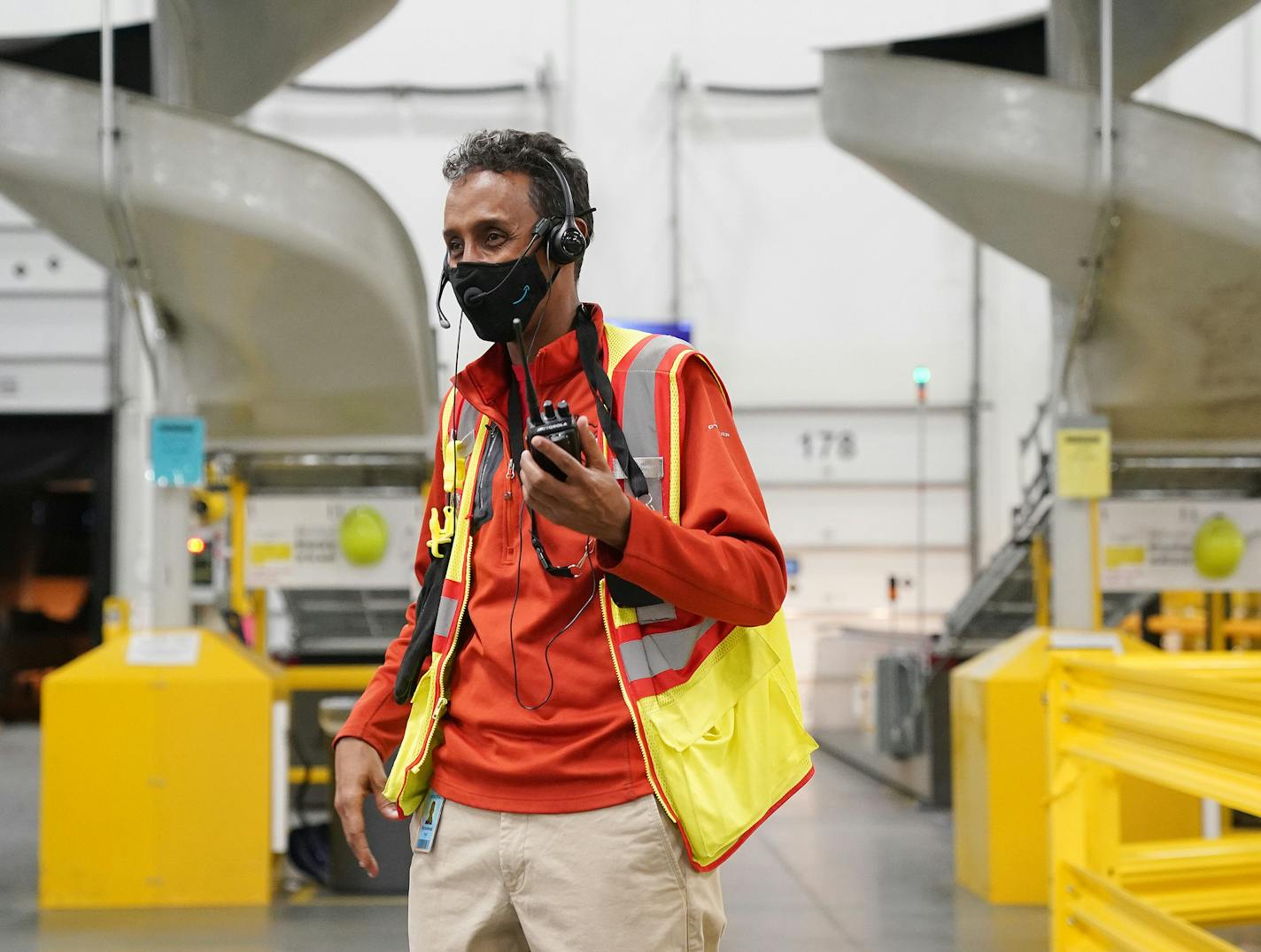 Operations manager Mahammud Hirsi listened on his radio at Amazon's Shakopee distribution center.