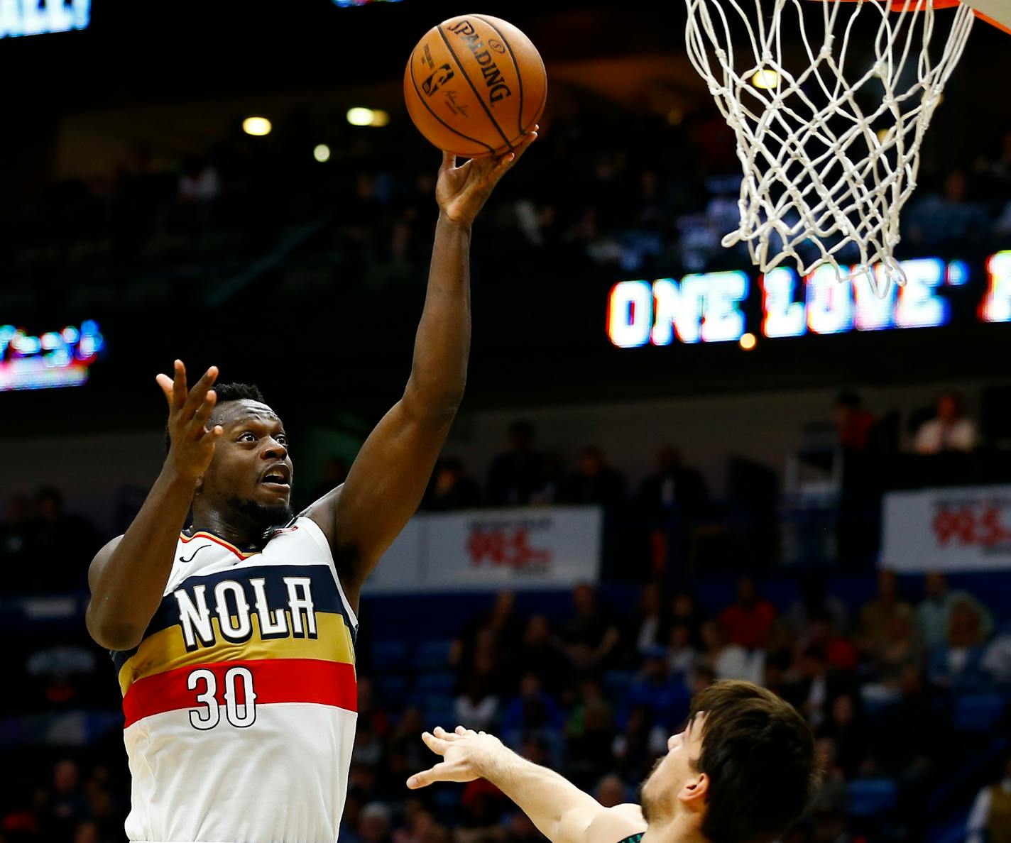 New Orleans Pelicans forward Julius Randle (30) shoots over Minnesota Timberwolves forward Dario Saric (36) during the second half of an NBA basketball game, Monday, Dec. 31, 2018, in New Orleans. (AP Photo/Butch Dill)