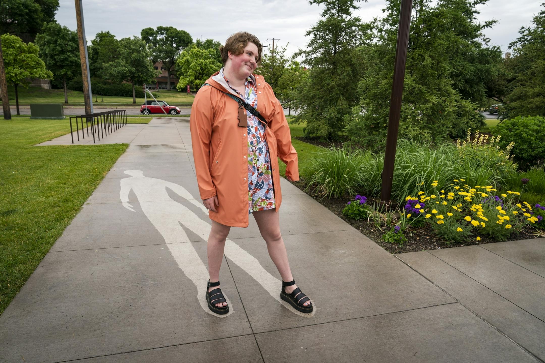Charli Birdwell, 18, of Chanhassen, a member of the Walker Art Center Teen Arts Council and shadow model for the piece, poses for a photo with "Kirk Washington, Jr." which only reveals itself when it rains, from the series "Shadows at the Crossroads" during the public unveiling.