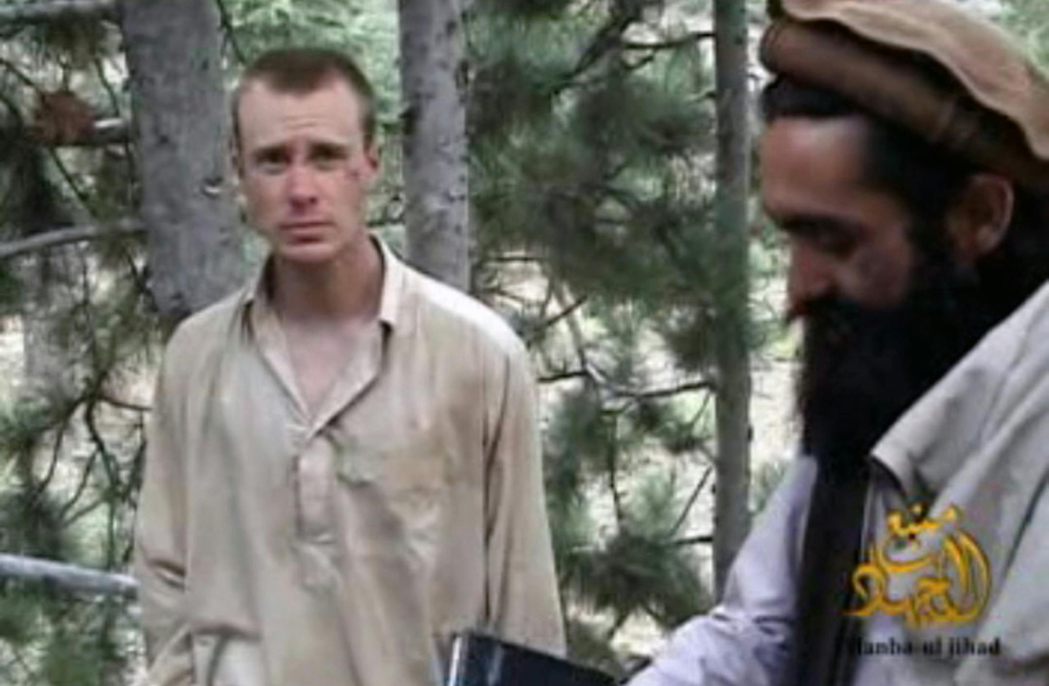 FILE - This file image provided by IntelCenter on Wednesday Dec. 8, 2010 shows a frame grab from a video released by the Taliban containing footage of a man believed to be Bowe Bergdahl, left. Afghanistan's Taliban says it has suspended "mediation" with the United States to exchange captive U.S. soldier Sgt. Bowe Bergdahl for five senior Taliban prisoners held in U.S. custody in Guantanamo Bay, halting ó at least temporarily ó what was considered the best chance yet of securing the 27-
