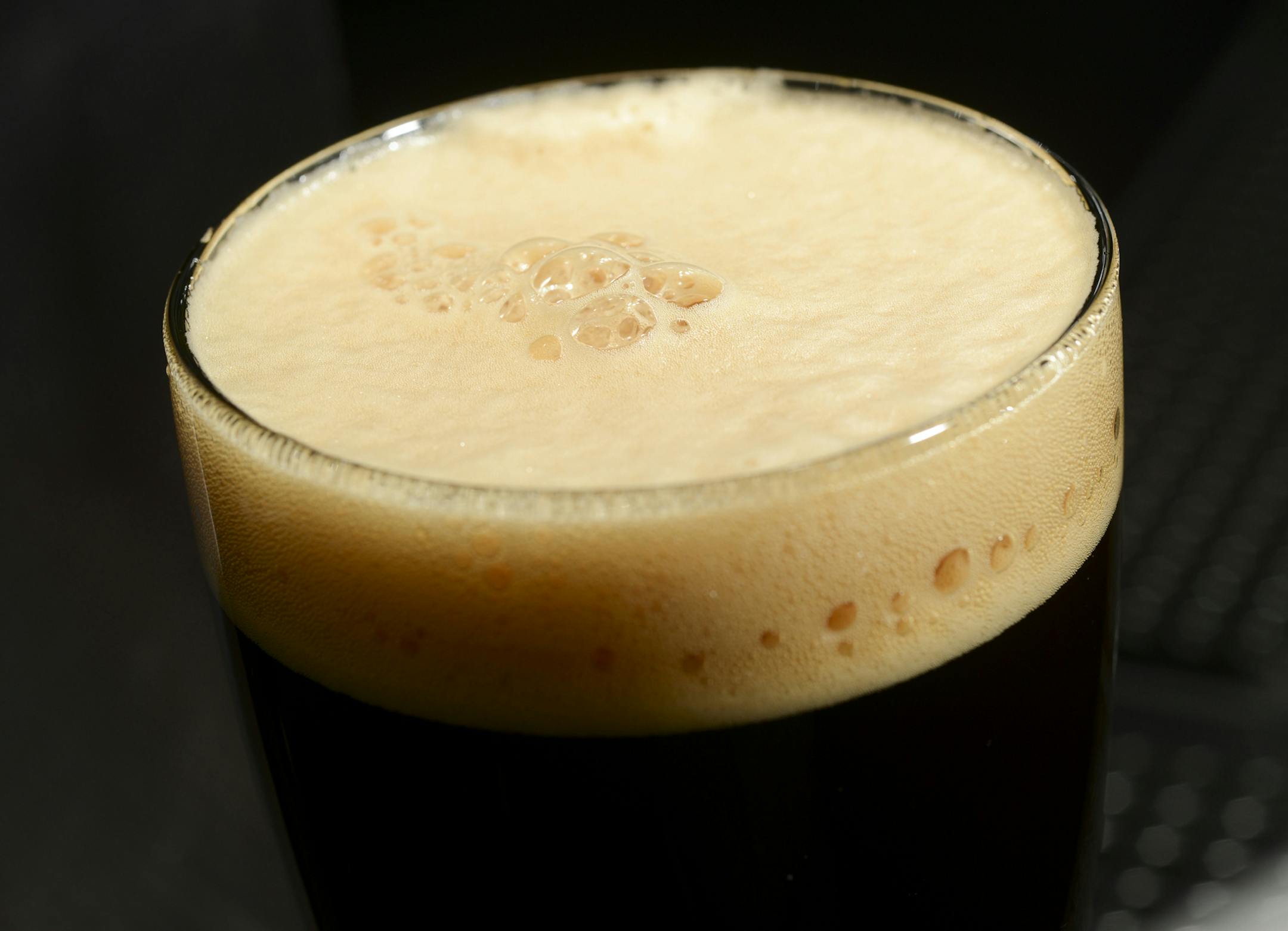 In this Dec. 30, 2013 photo, the light brown head on a glass of India Brown Ale is seen at Hopvine Brewing Co. in Aurora, Ill. (AP Photo/Daily Herald, Mark Black)