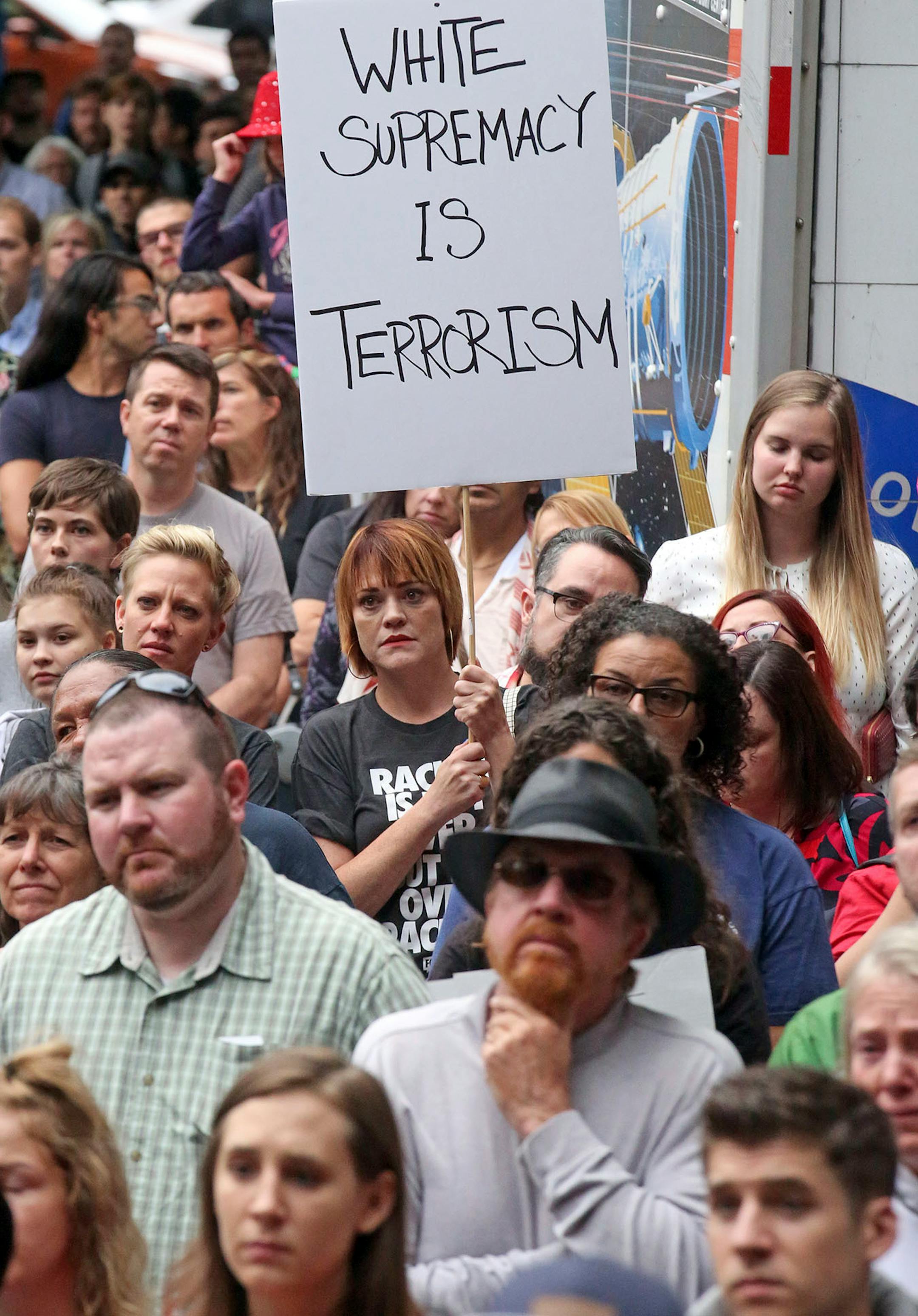 People attend a rally Monday, Aug. 14, 2017, in Salt Lake City. Utah residents are holding unity and anti-racism rallies Monday night to denounce the messages of hate and violence of white supremacists at a weekend rally in Charlottesville, Va.