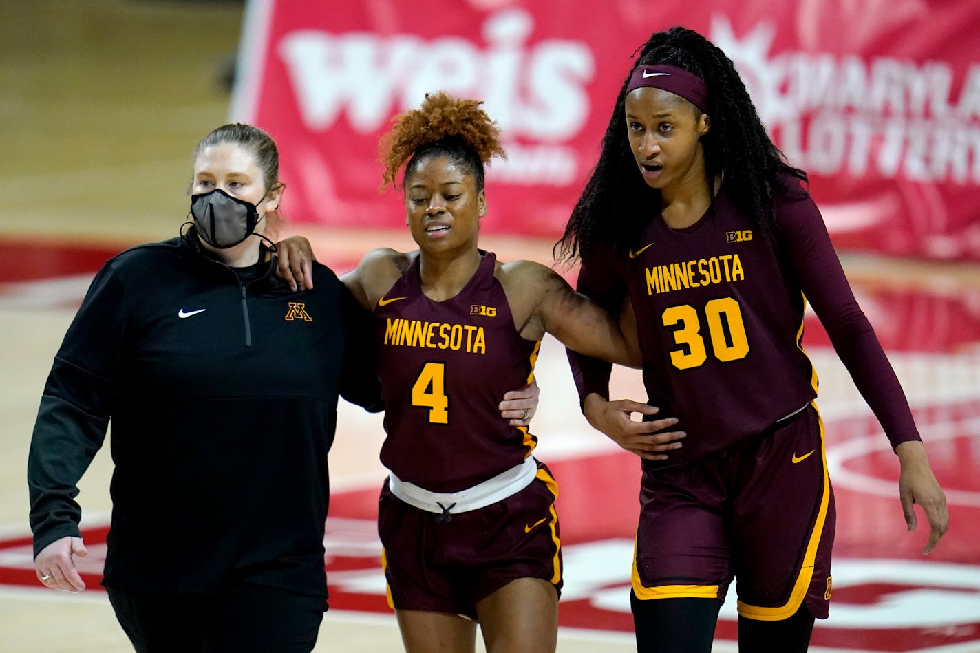 Gophers guard Jasmine Powell (4) is helped off the court on Feb. 20 at Maryland. She is not expected to play Friday at Illinois.