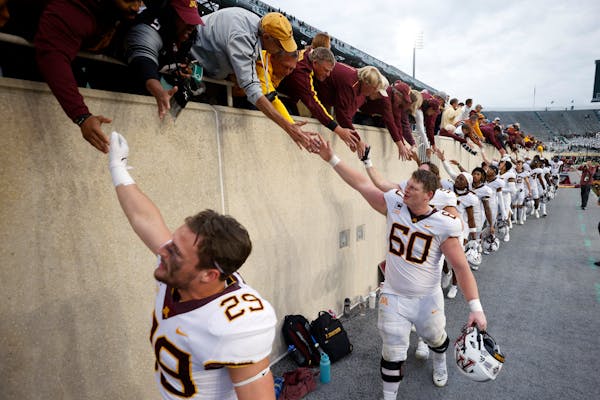 Minnesota players celebrate with fans following an NCAA college football game against Michigan State, Saturday, Sept. 24, 2022, in East Lansing, Mich.