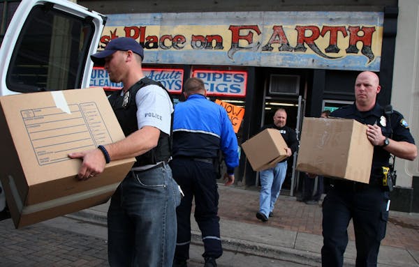 File photo: At the Last Place On Earth head shop in Duluth, police officers removed about a dozen boxes and high powered rifles from the store that se