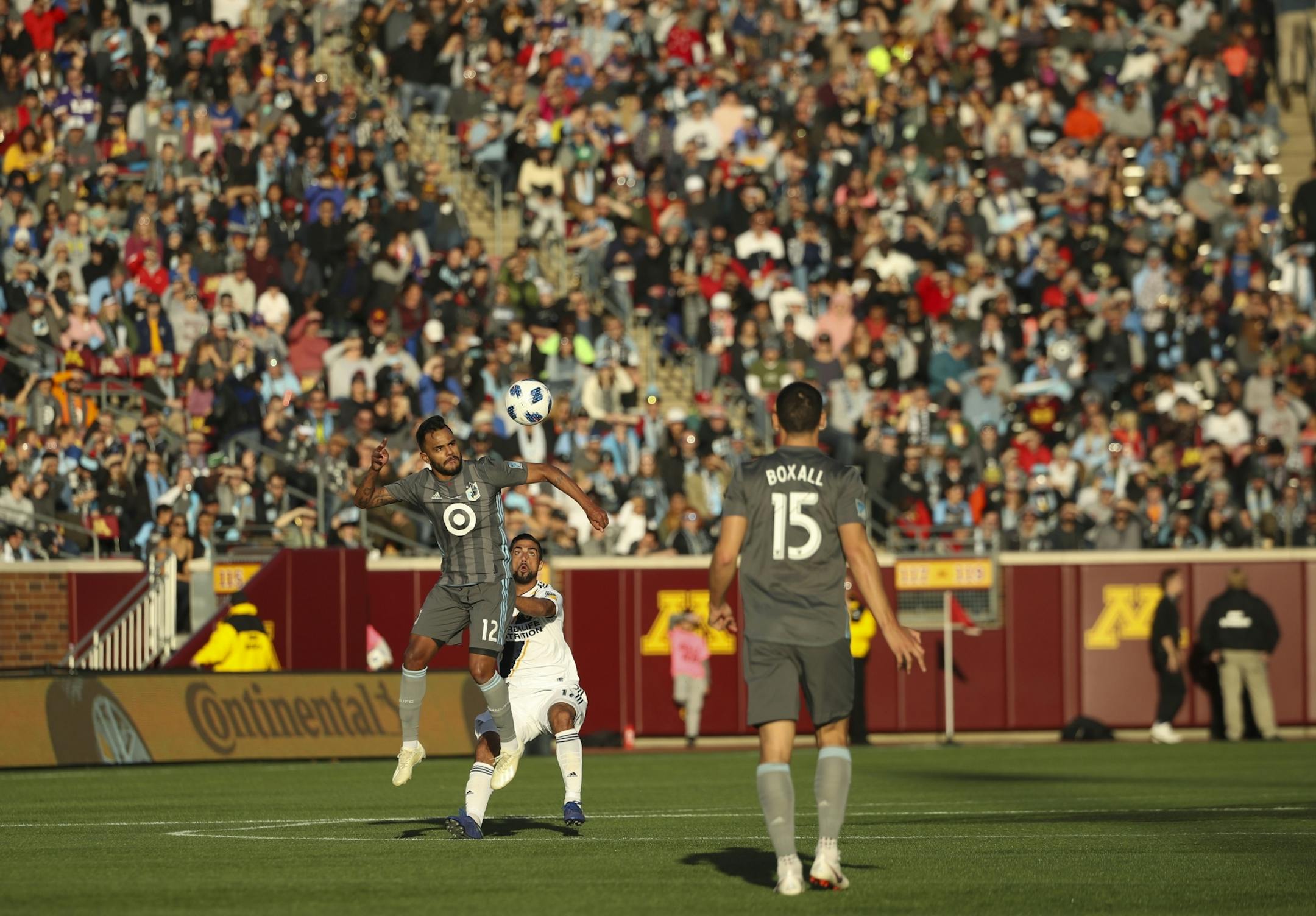 Minnesota United midfielder Fernando Bob (12) prepared to head the ball in the first half while defended by Los Angeles Galaxy midfielder Sebastian Lletget (17).