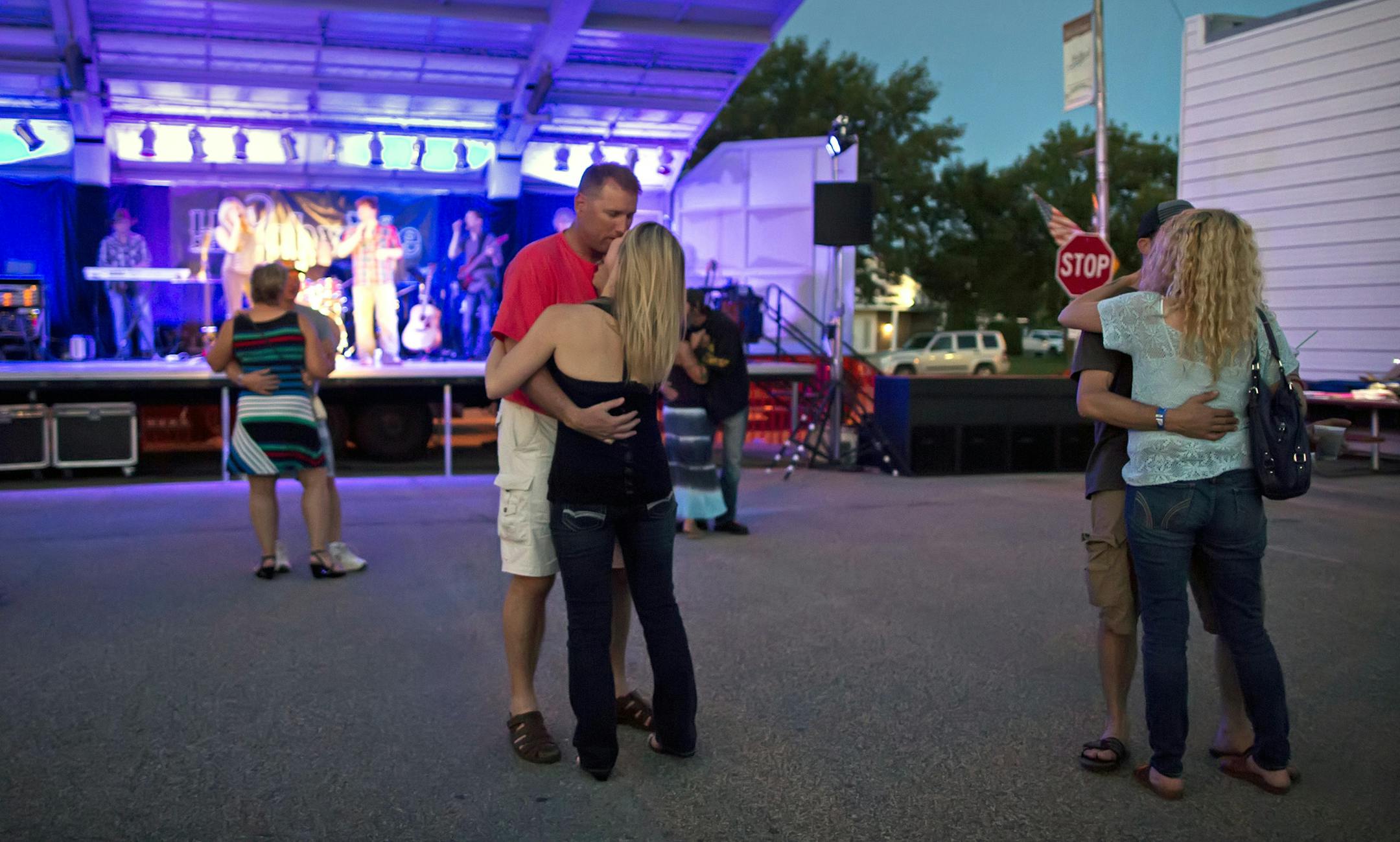 The Medford Straight River Days street dance attracted over 300 people to town on a recent Saturday night. With music by Hitchville and a beer, barbeque and cheese curds, the night was topped off by a beautiful crescent moon and temperatures in the upper 70's. Here, Jonas Mork and Rachael Briggs (center) dance to a slow tune. More came back for the 100-year anniversary of the Medford School. He was an 1986 grad. ] Brian.Peterson@startribune.com Medford, MN - 6/20/2015