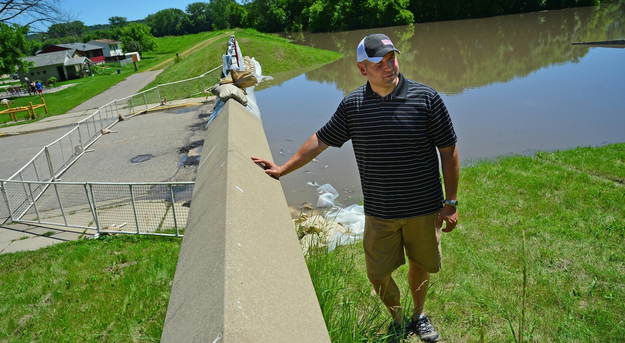 Henderson Mayor Paul Menne has been checking the dike that protects the town several times a day.]Flooding and the aftermath of heavy rains are still being felt in Henderson, several roads are closed by mudslides and flooding..Richard.Sennott@startribune.com Richard Sennott/Star Tribune Henderson Minn. Saturday 6/21/2014) ** (cq)