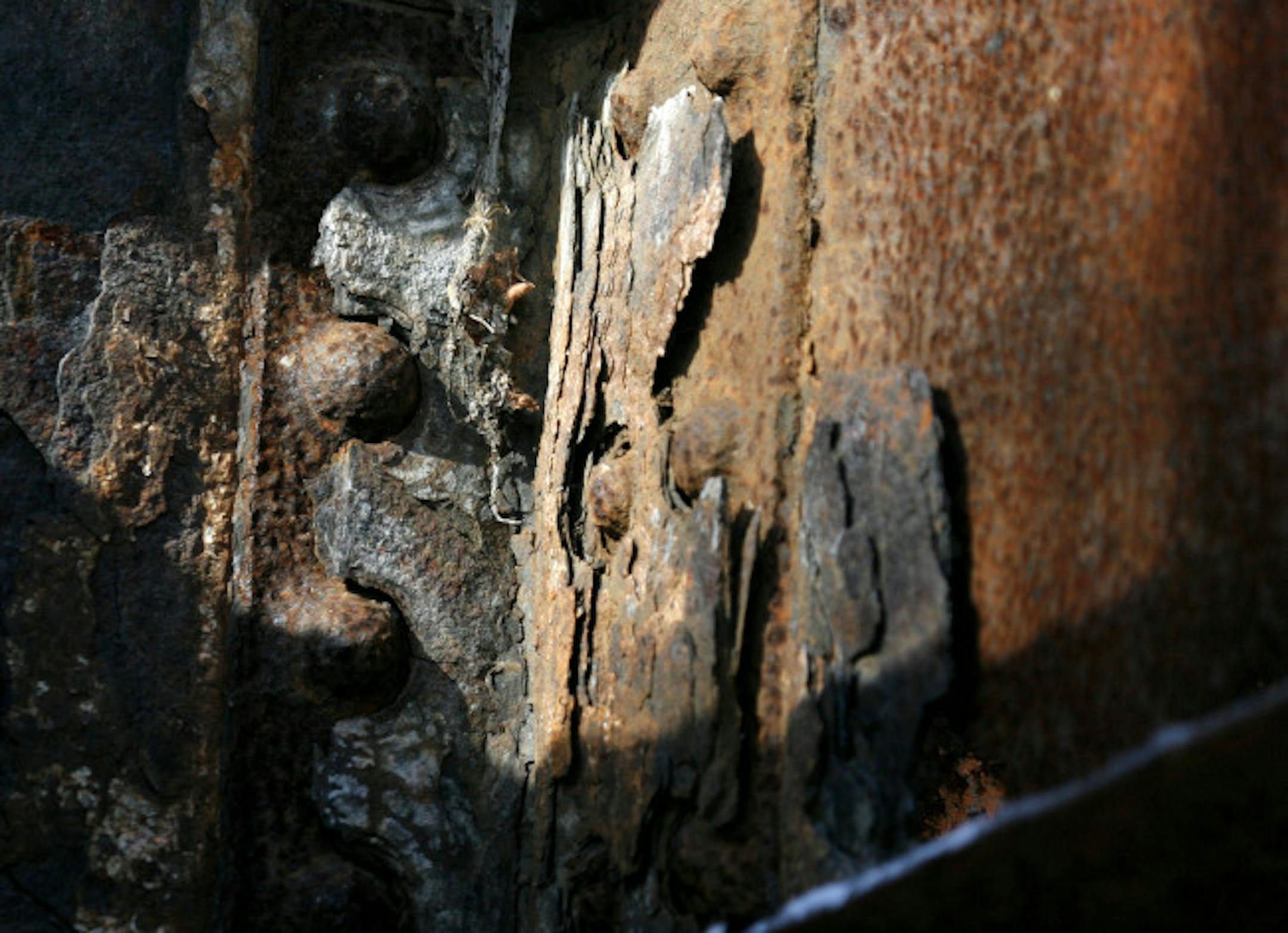 A closeup of a metal support beam and bolt on the Old Cedar Avenue Bridge. Built in 1890 and closed to car traffic almost a 100 years later, the swing bridge, its girders severely corroded, is now closed to foot traffic as well and its fate yet to be decided.