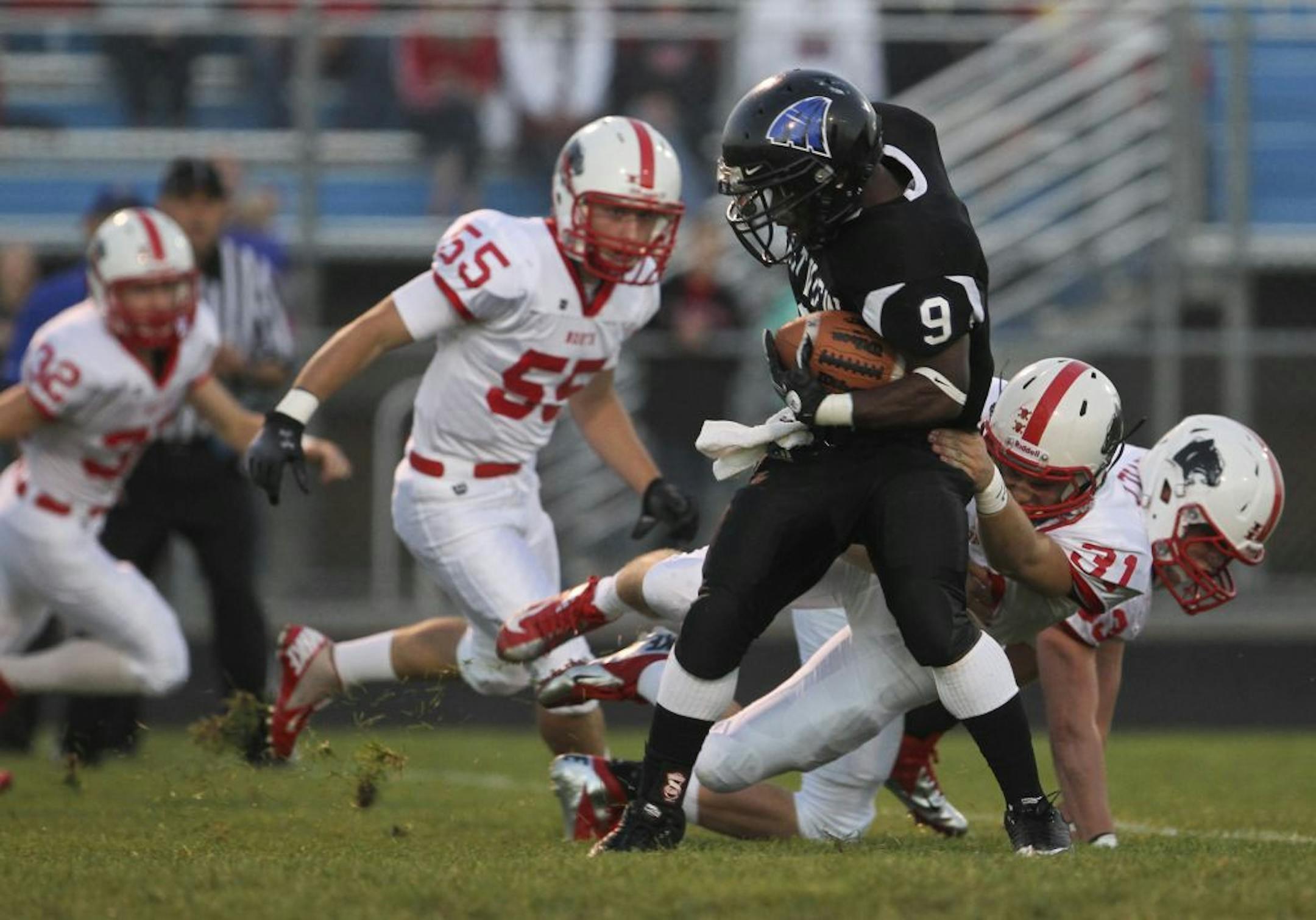 Eastview High's Amari Kennedy (9) sheds a tackle by Lakeville North's Chris Peterson (31) en route to a long first half kick return Friday, Sept. 14, 2012, in Apple Valley, MN. (DAVID JOLES/STARTRIBUNE) djoles@startribune.com Lakeville North at Eastview High Friday, Sept. 14, 2012 in Apple Valley, MN.**Amari Kennedy, Chris Peterson,cq
