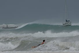 A surfer braves the waves in Carlisle Bay as Hurricane Beryl passes through Bridgetown, Barbados, Monday, July 1, 2024. (AP Photo/Ricardo Mazalan)