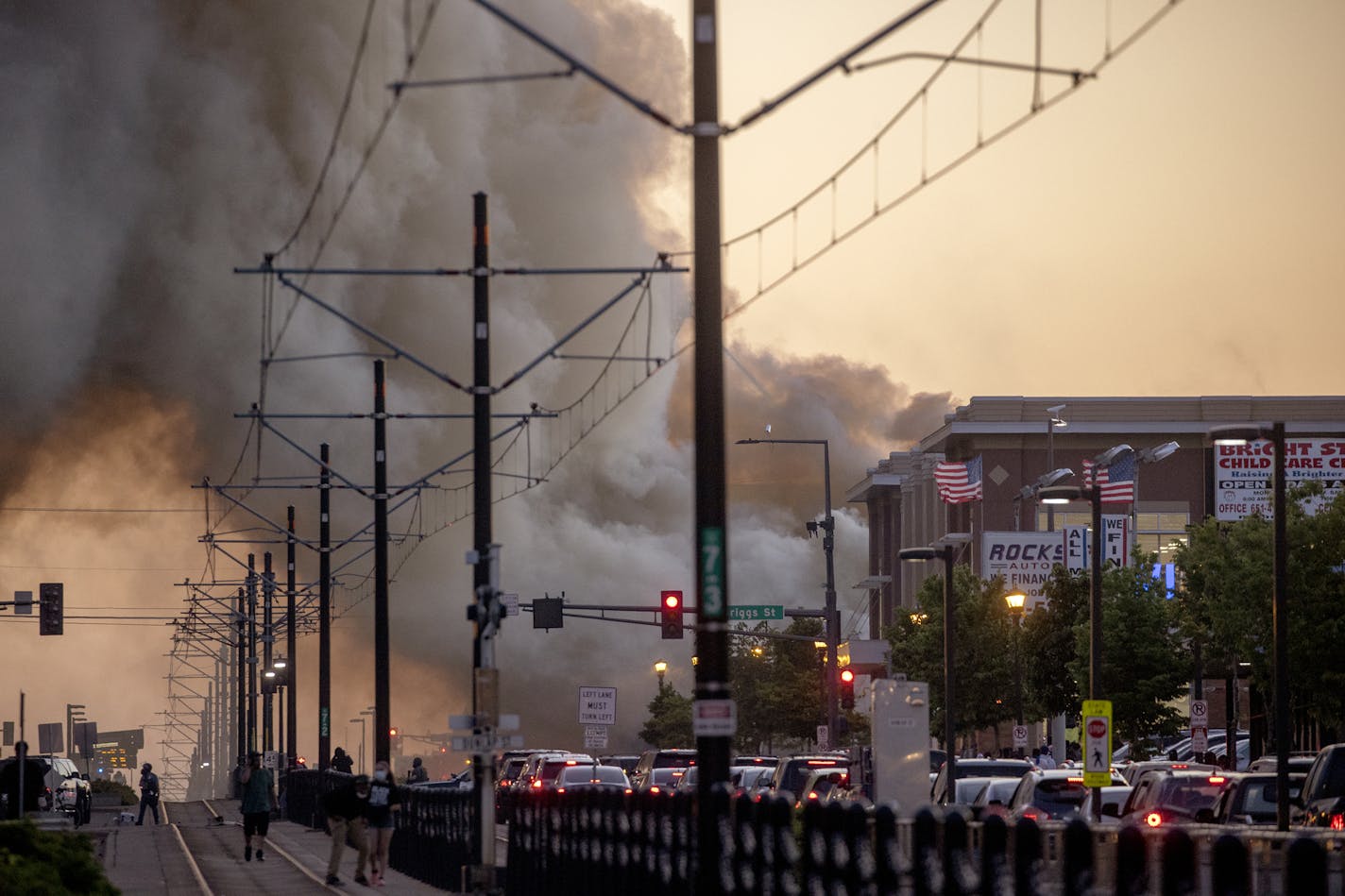 Smoke rises from fires as seen from University Avenue on Thursday, May 28, 2020, in St. Paul, Minn. Anger over the death of George Floyd, a handcuffed black man in police custody, spread beyond Minneapolis on Thursday, with looting and fires set along a major St. Paul street and protesters returning to a neighborhood already ravaged by violent protest. (Elizabeth Flores/Star Tribune via AP)