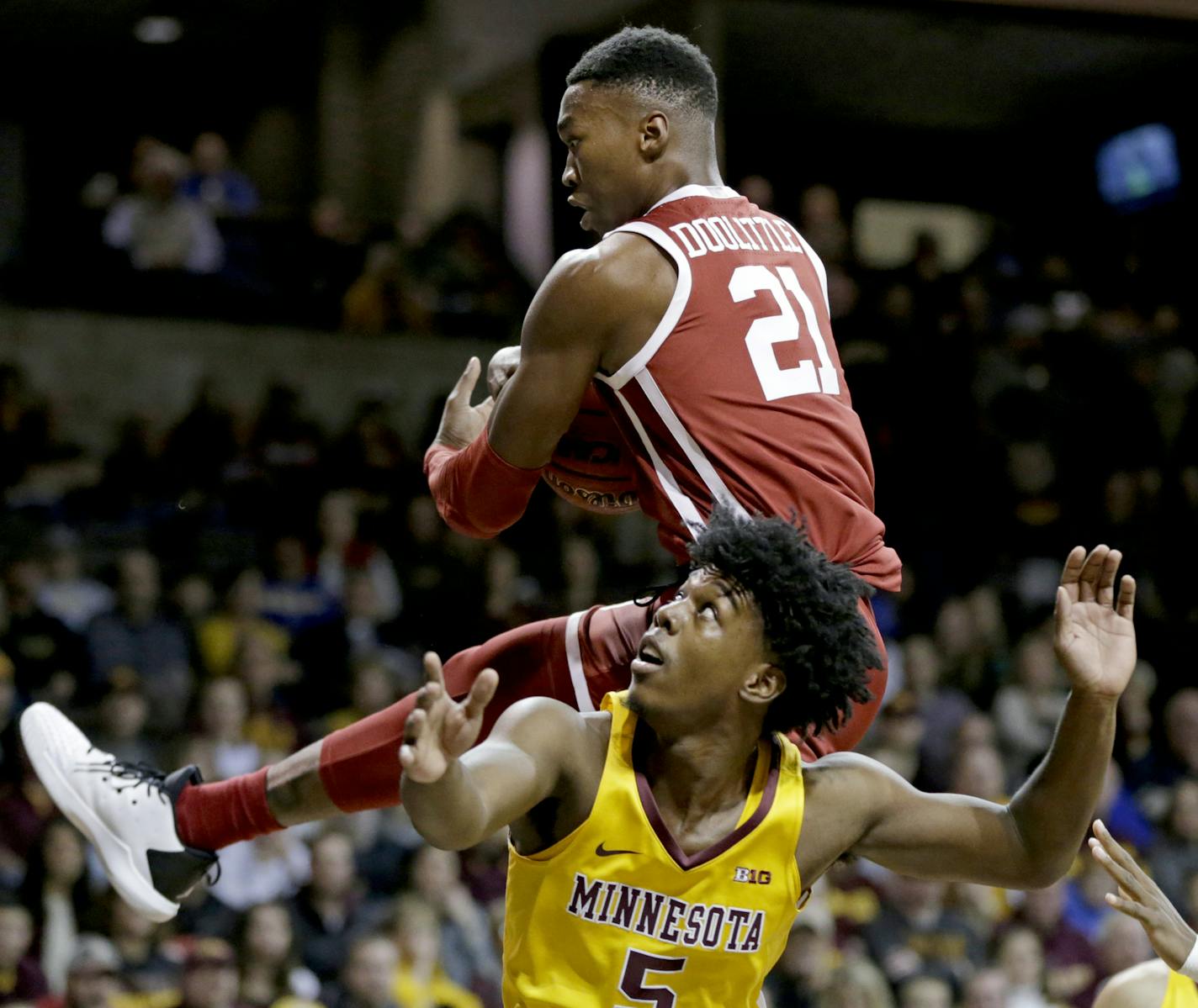 Oklahoma's Kristian Doolittle (21) grabs a rebound over Minnesota's Marcus Carr (5) during the first half of an NCAA college basketball game in Sioux Falls, S.D., Saturday, Nov. 9, 2019. (AP Photo/Nati Harnik)