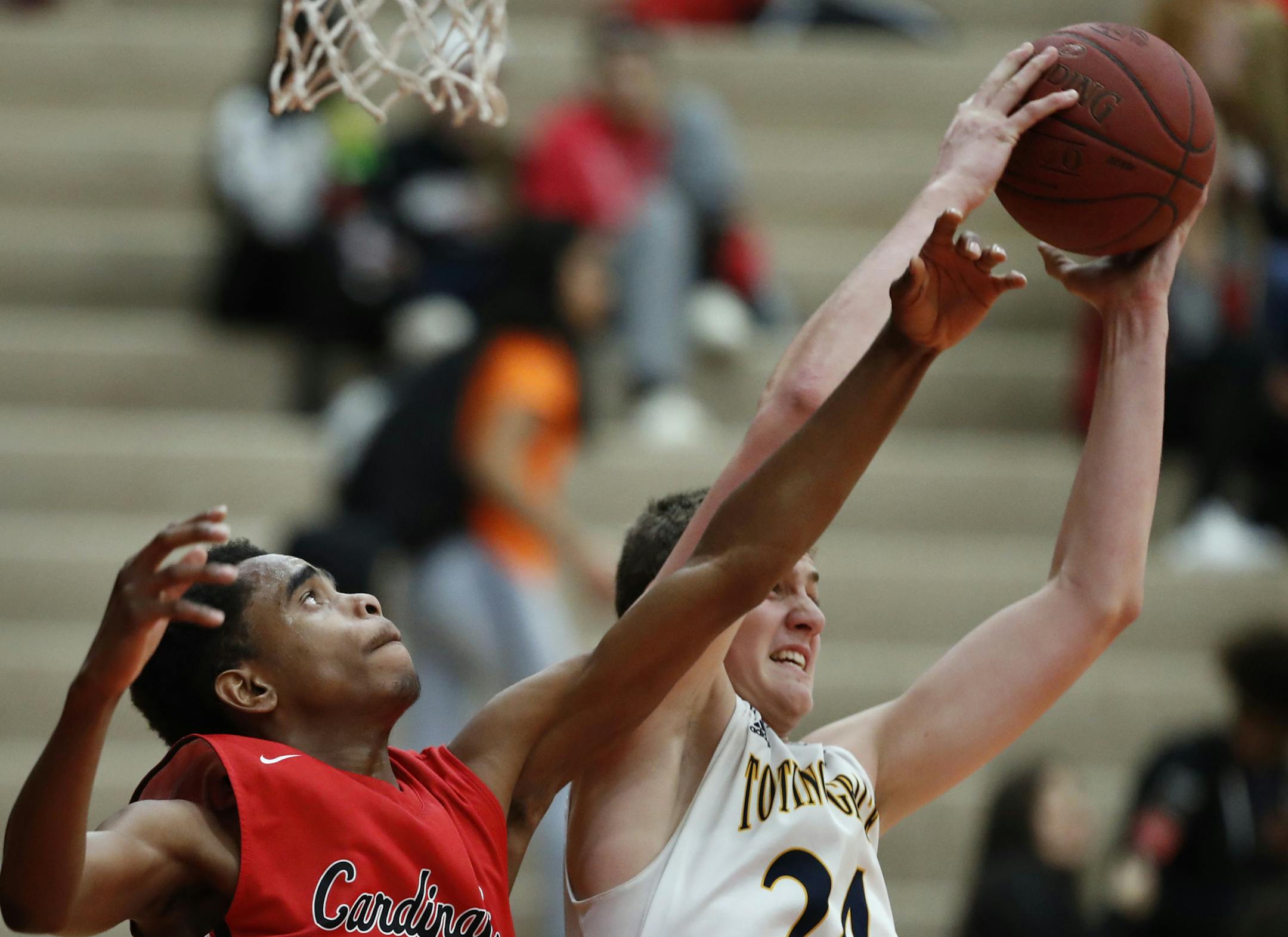 Tyree' on Johnson left battled Totino-Grace forward Rocky Kreuser for a rebound at Coon Rapids High school Tuesday January 24, 2017 in Coon Rapids, MN.] Coon Rapids played Totino-Grace in boyís basketball. JERRY HOLT ï jerry.holt@startribune.com