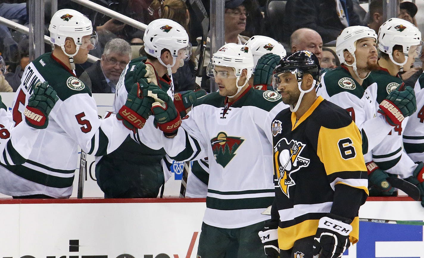 Minnesota Wild's Nino Niederreiter (22) returns to teh bench after his goal as Pittsburgh Penguins' Trevor Daley (6) skates past during the second period of an NHL hockey game in Pittsburgh, Thursday, Nov. 10, 2016. (AP Photo/Gene J. Puskar)