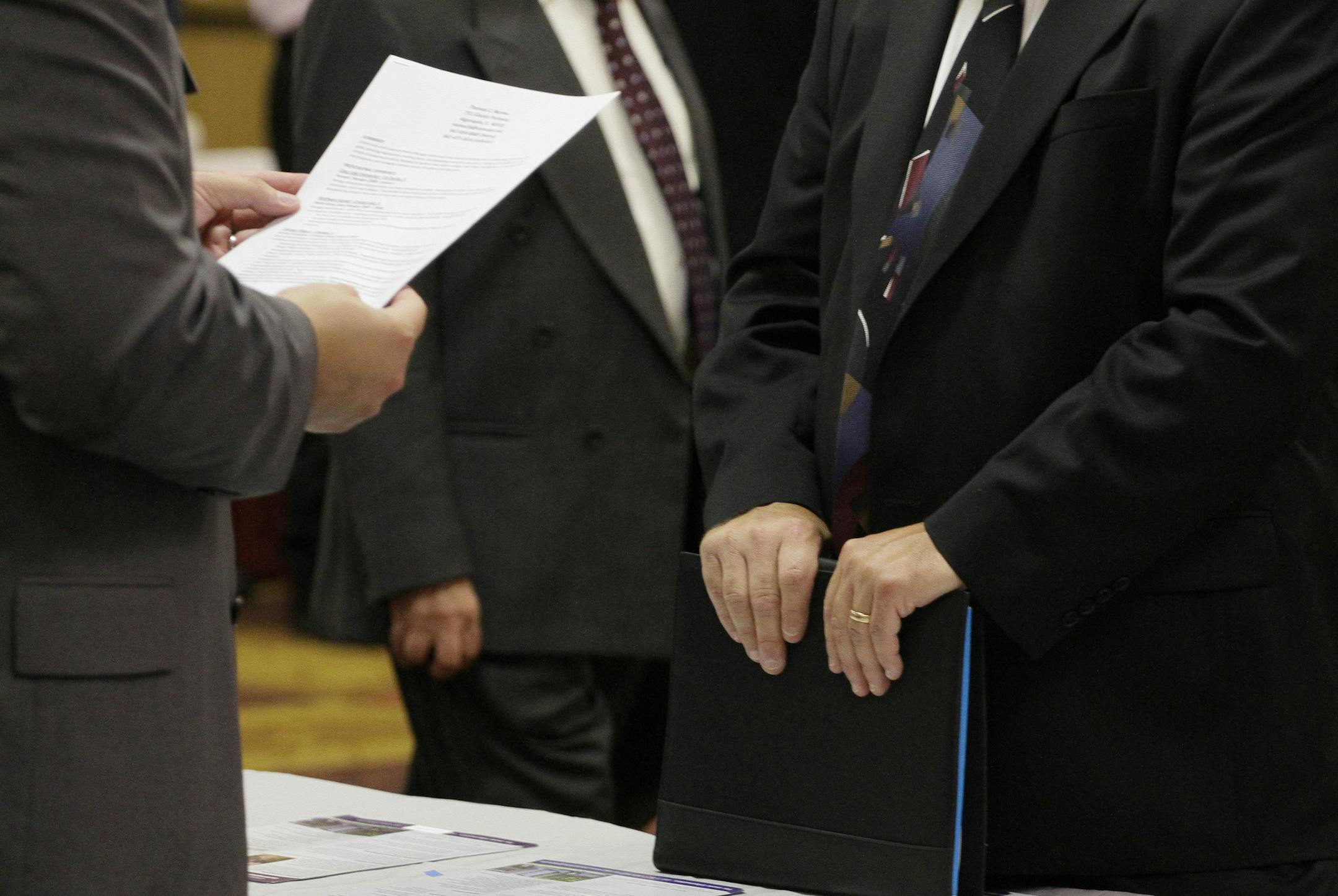 In this Aug. 31, 2010 photograph, Tom Nemee, of Algonquin, Ill., right, speaks with a recruiter at a career fair, in Rolling Meadows, Ill. Nemee is looking for work in customer service or sales management. First-time unemployment claims drop to 450K, the third decline in four weeks. (AP Photo/M. Spencer Green) ORG XMIT: ILMG206