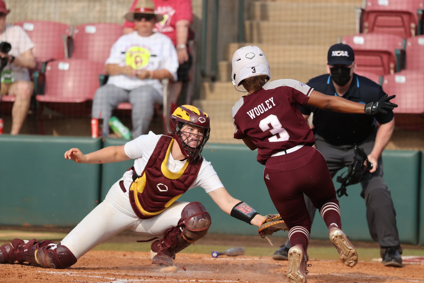 Gophers catcher Sara Kinch prepared to apply a tag on Texas A&amp;M's Koko Wooley during the sixth inning of an NCAA softball tournament game on May 20, 2022 in Norman, Okla. Wooley was out on a fielder's choice. (Craig Bisacre, University of Minnesota athletics)