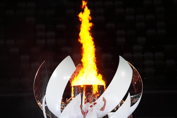 Tennis star Naomi Osaka lit the Olympic flame at Olympic Stadium during the Opening Ceremony in Tokyo on Friday.