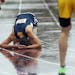 Totino Grace's Brandon Hilliard collapsed on the wet track after finishing in the 4x800 meter relay. ] (KYNDELL HARKNESS/STAR TRIBUNE) kyndell.harknes