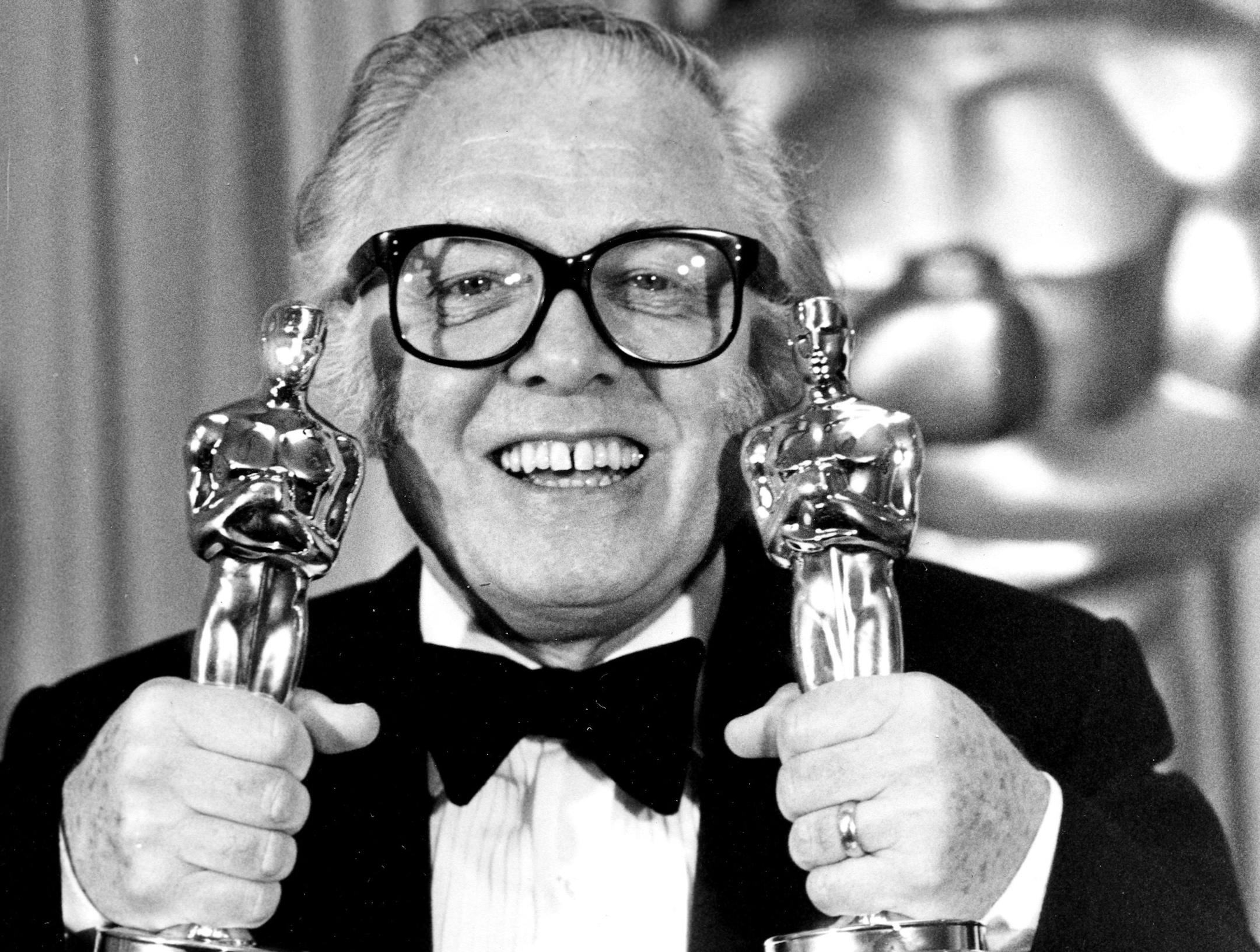 FILE - In this Monday, April 11, 1983 file photo, British actor and director Richard Attenborough holds his two Oscars for his epic movie "Gandhi" at the 55th annual Academy Awards in Los Angeles, Ca.,. Acclaimed actor and Oscar-winning director Richard Attenborough, whose film career on both sides of the camera spanned 60 years, died on Sunday, Aug. 24, 2014. He was 90. (AP Photo, File)