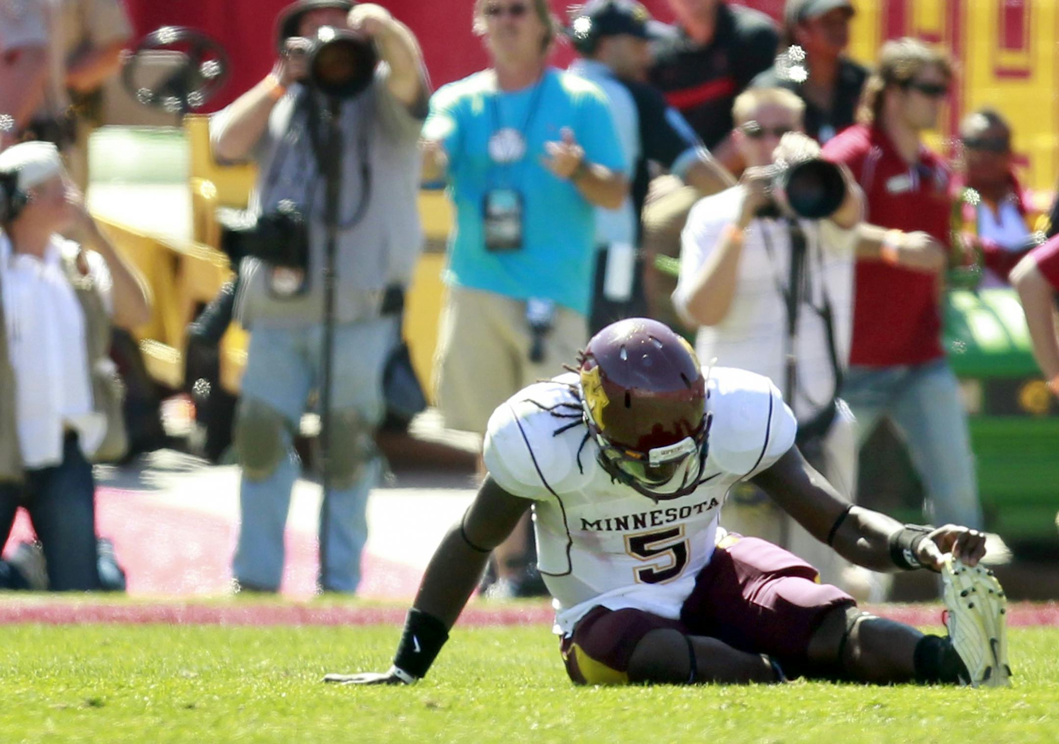 Minnesota quarterback MarQueis Gray (5) held his foot on the field in the third quarter. Gray left the game and did not return.