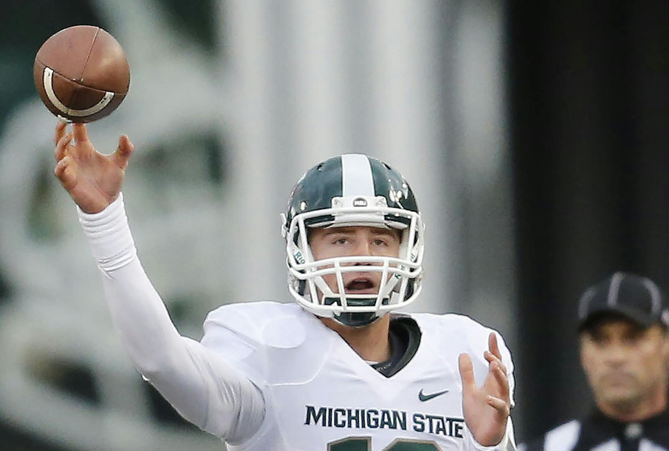 Michigan State quarterback Connor Cook (18) throws against Indiana’s Bobby Richardson (95) during the first half of a NCAA college football game, Saturday, Oct. 18, 2014 in Bloomington, Ind. (AP Photo/Sam Riche)