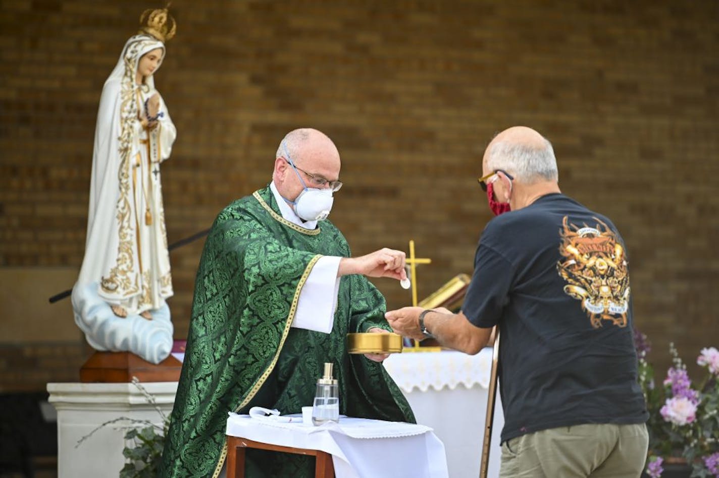 Transfiguration Catholic Church Fr. Brian Lynch gave to communion to mass goers Wednesday night.